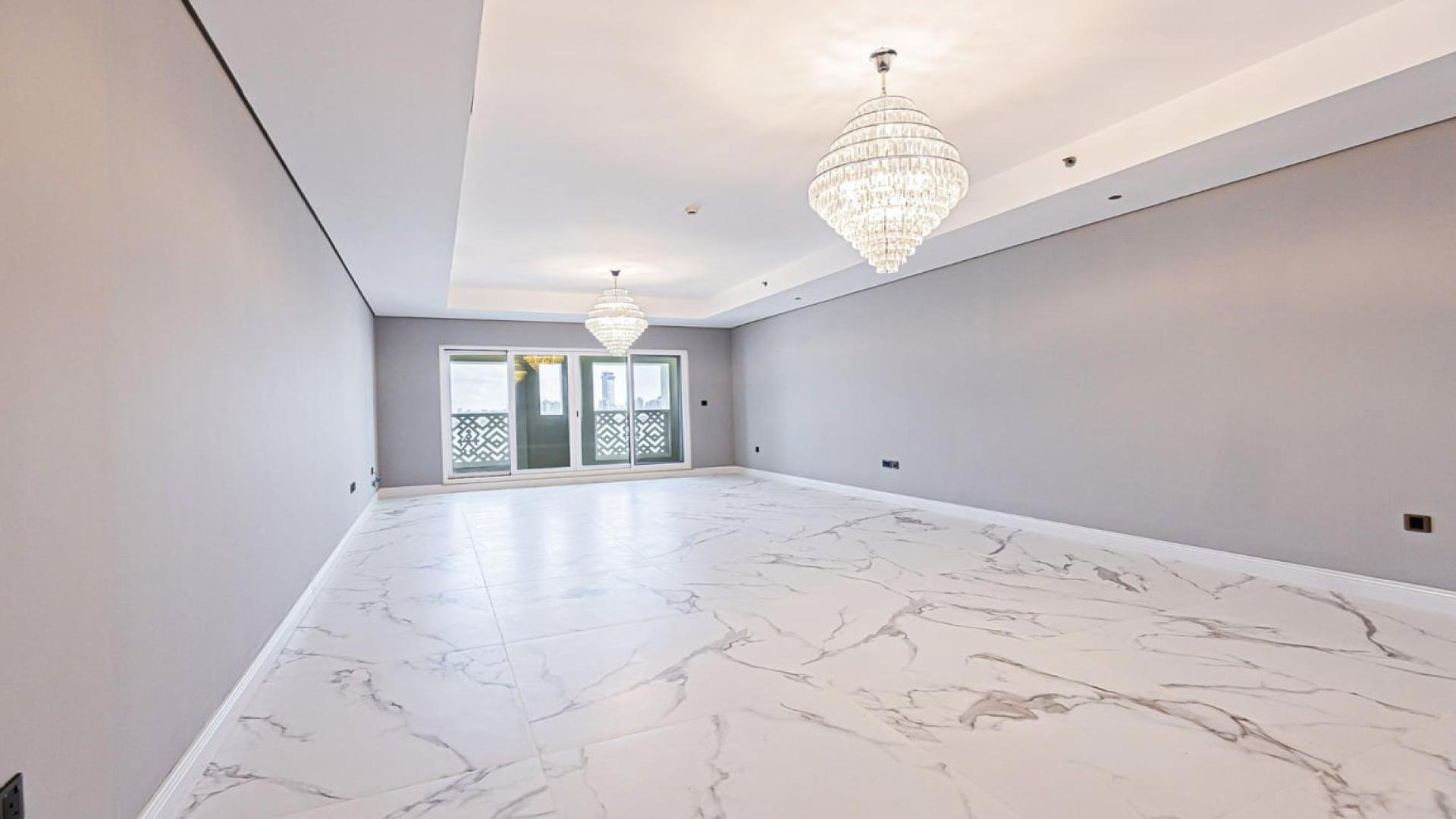 Spacious living room with chandeliers, marble flooring in Palm Jumeirah apartment for rent