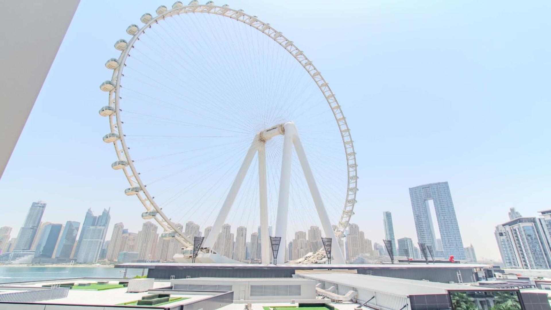 Luxurious Bluewaters apartment living room with Ain Dubai view, modern furnishings, bright ambiance