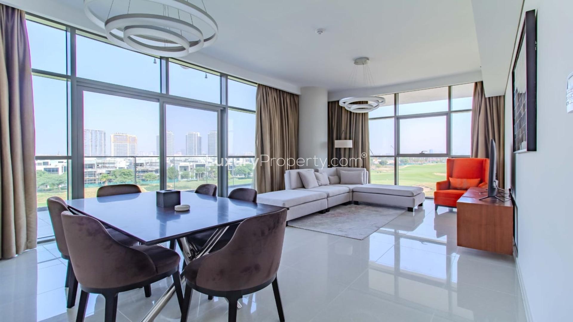 "Golf course view from spacious furnished apartment in Damac Hills, NAIA Golf Terrace.",Spacious furnished apartment living room with golf course view, Damac Hills, NAIA Golf Terrace