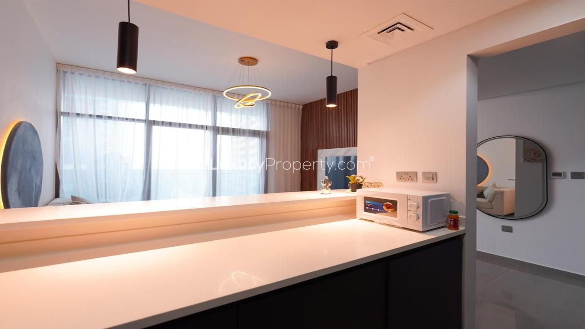 Furnished living room in Merano Tower apartment, Business Bay, with modern decor and open kitchen