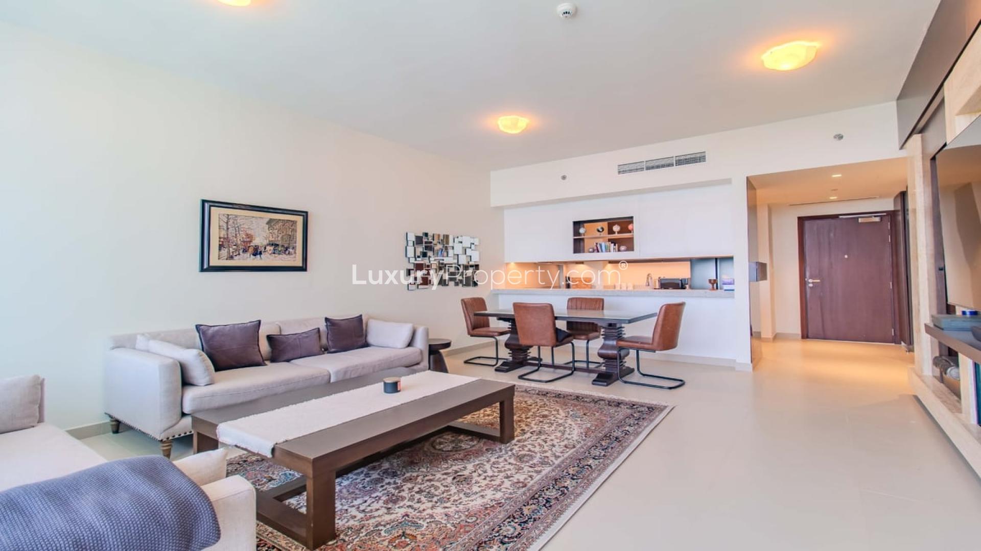 Furnished living room with large windows and park view in Park Heights apartment