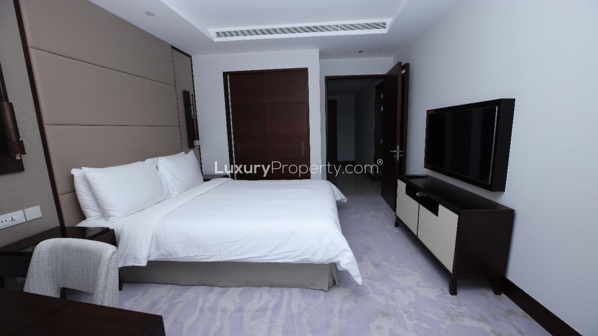 Furnished bedroom in high-floor apartment, Sky View Towers, Downtown Dubai, with city view balcony