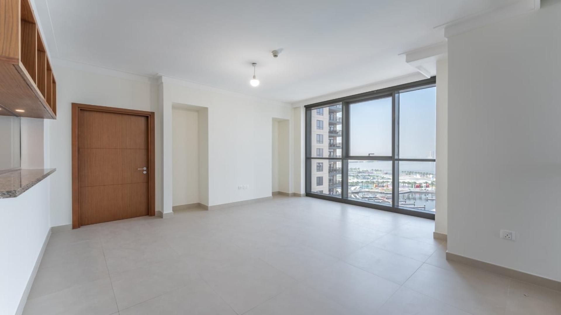 Spacious living area with large windows in Dubai Creek Harbour apartment for rent