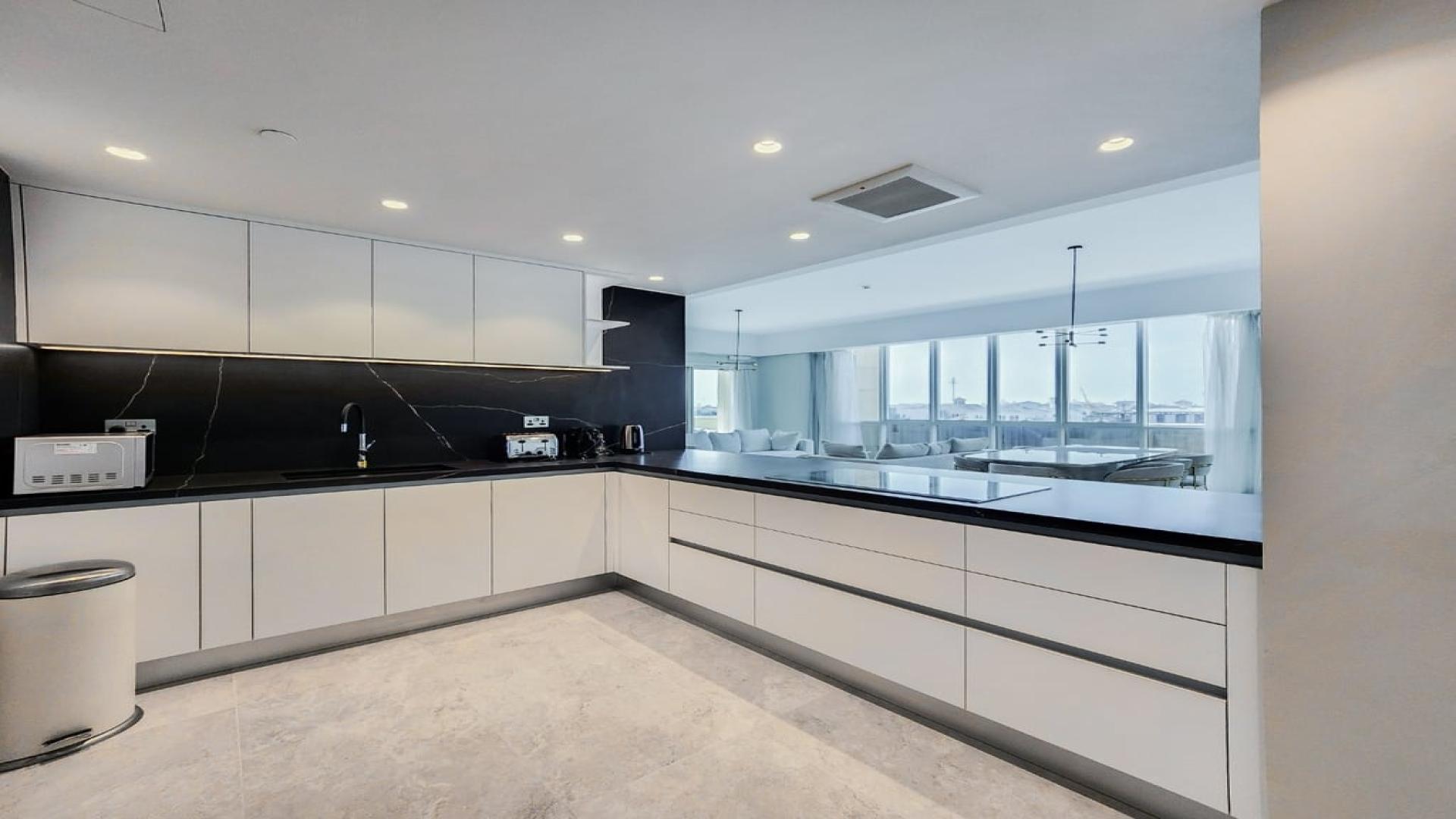 Modern living room in Marina Residences apartment, Palm Jumeirah, with TV and seating area