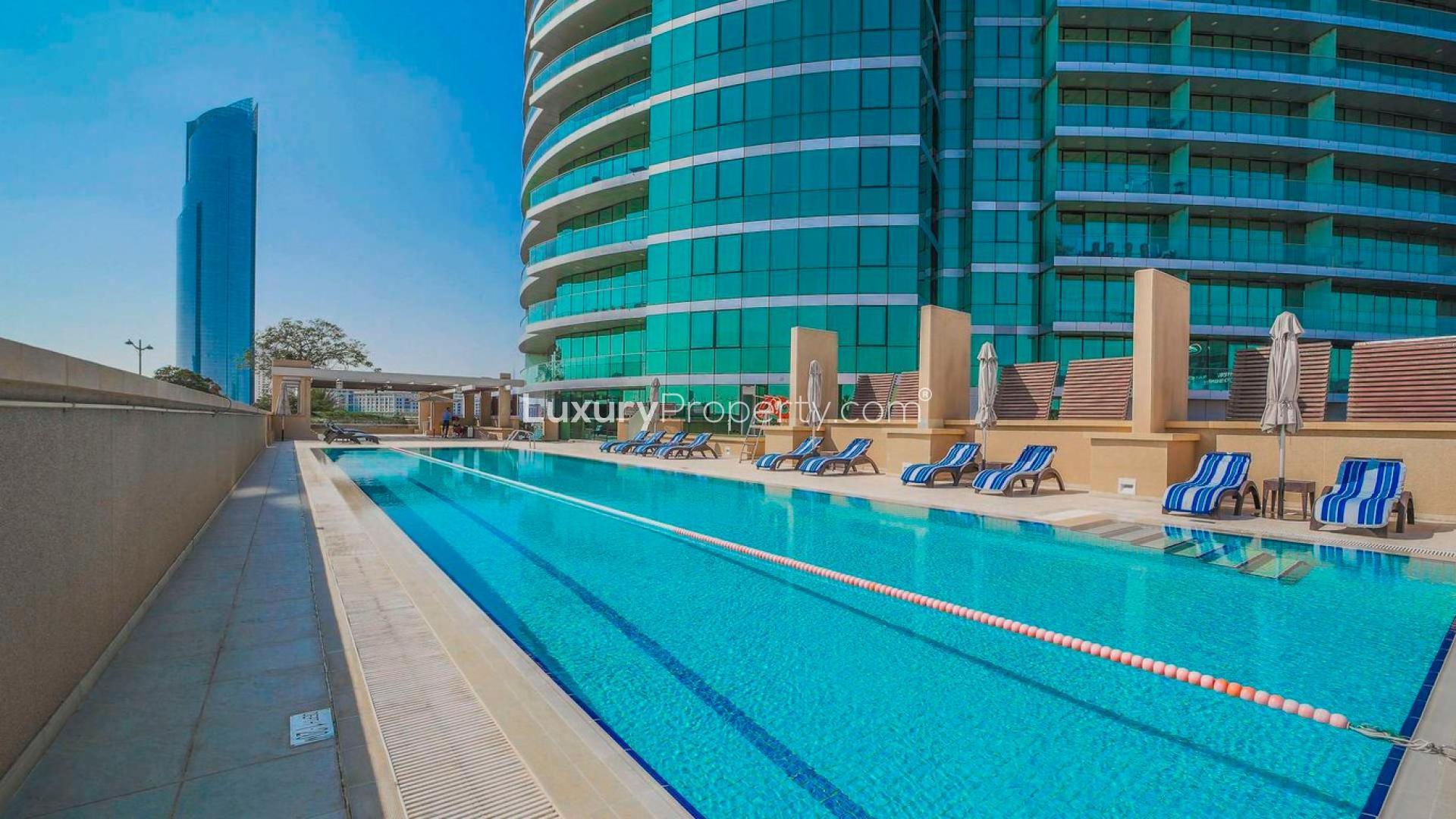 "Modern Marsa Plaza apartment building exterior at Dubai Festival City for sale.",Outdoor swimming pool at Marsa Plaza, Dubai Festival City apartment complex for sale