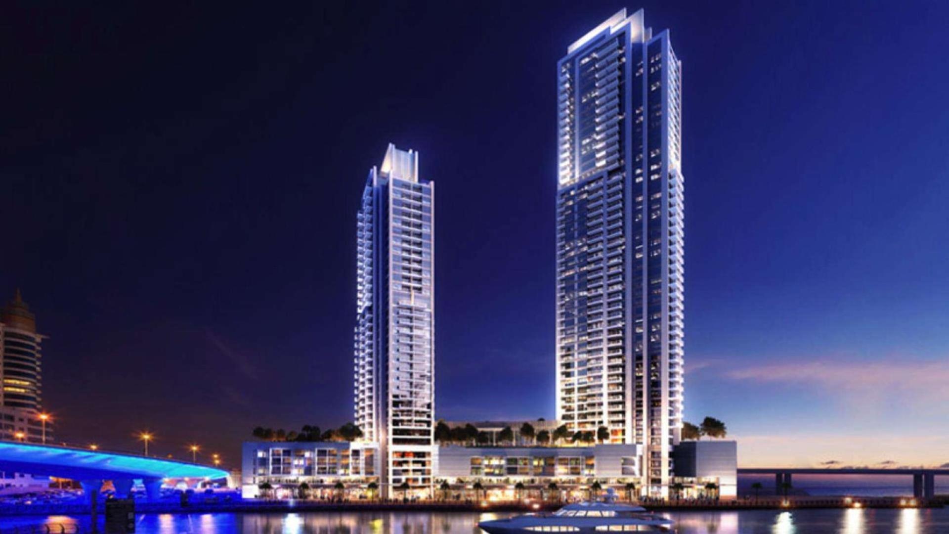 Contemporary waterfront apartments in Dubai Marina, night view with yacht and skyline reflections