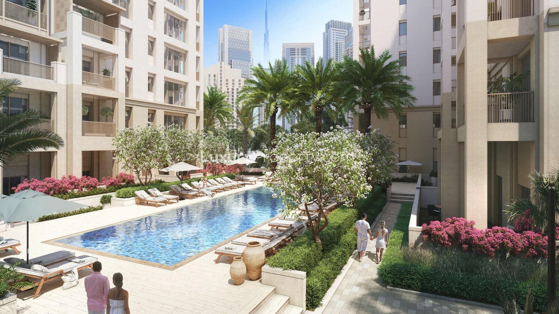 "Spacious living room in 3-bedroom luxury apartment, Breeze, Dubai Creek Harbour, with city views.",Luxury waterfront apartment pool area at Breeze, Dubai Creek Harbour with lush landscaping