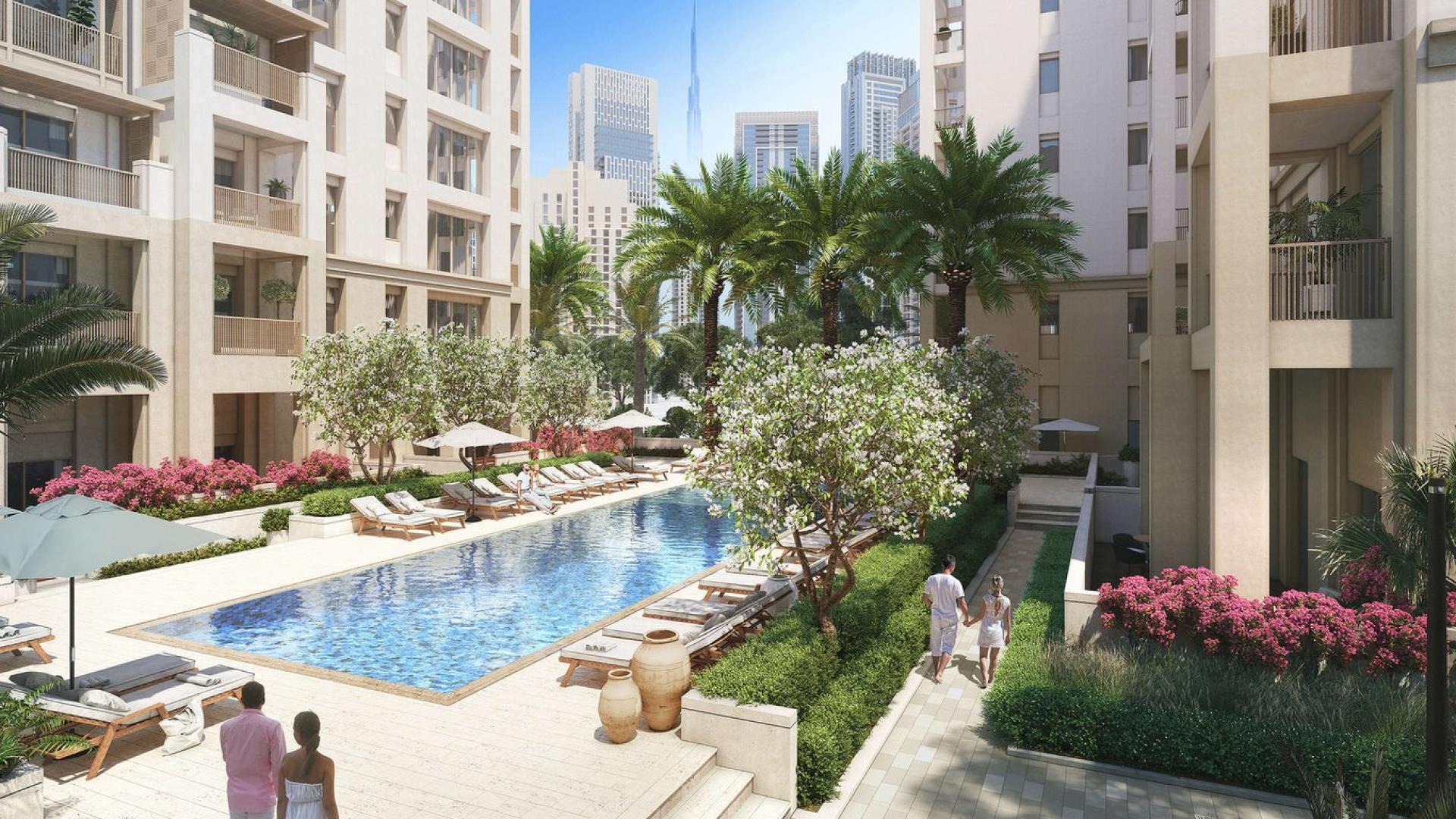 "Spacious living room in 3-bedroom luxury apartment, Breeze, Dubai Creek Harbour, with city views.",Luxury waterfront apartment pool area at Breeze, Dubai Creek Harbour with lush landscaping