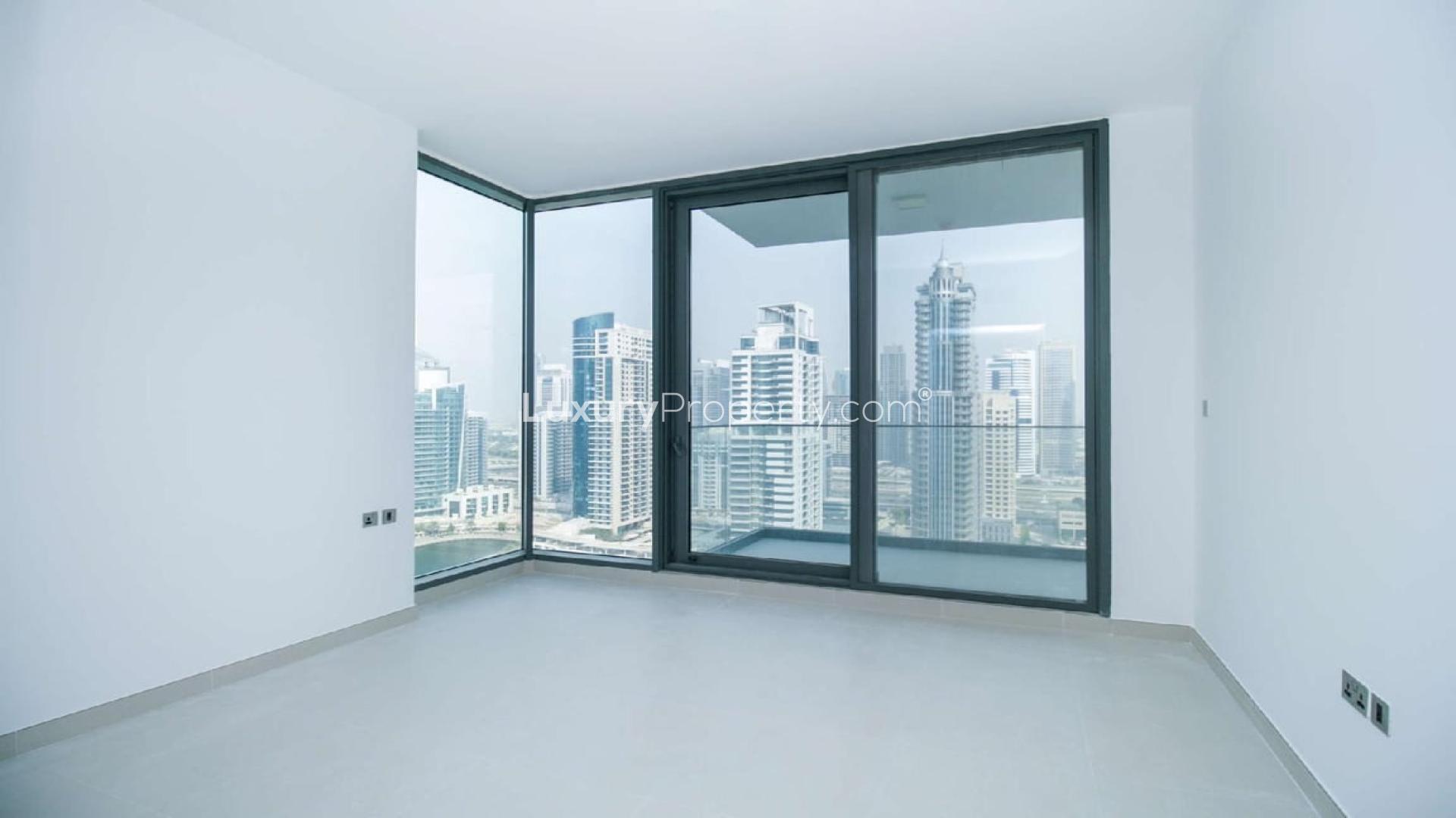 "Spacious living room with large windows, Dubai Marina view, LIV Residence apartment for sale.",Spacious living area with large windows in Liv Residence apartment, Dubai Marina