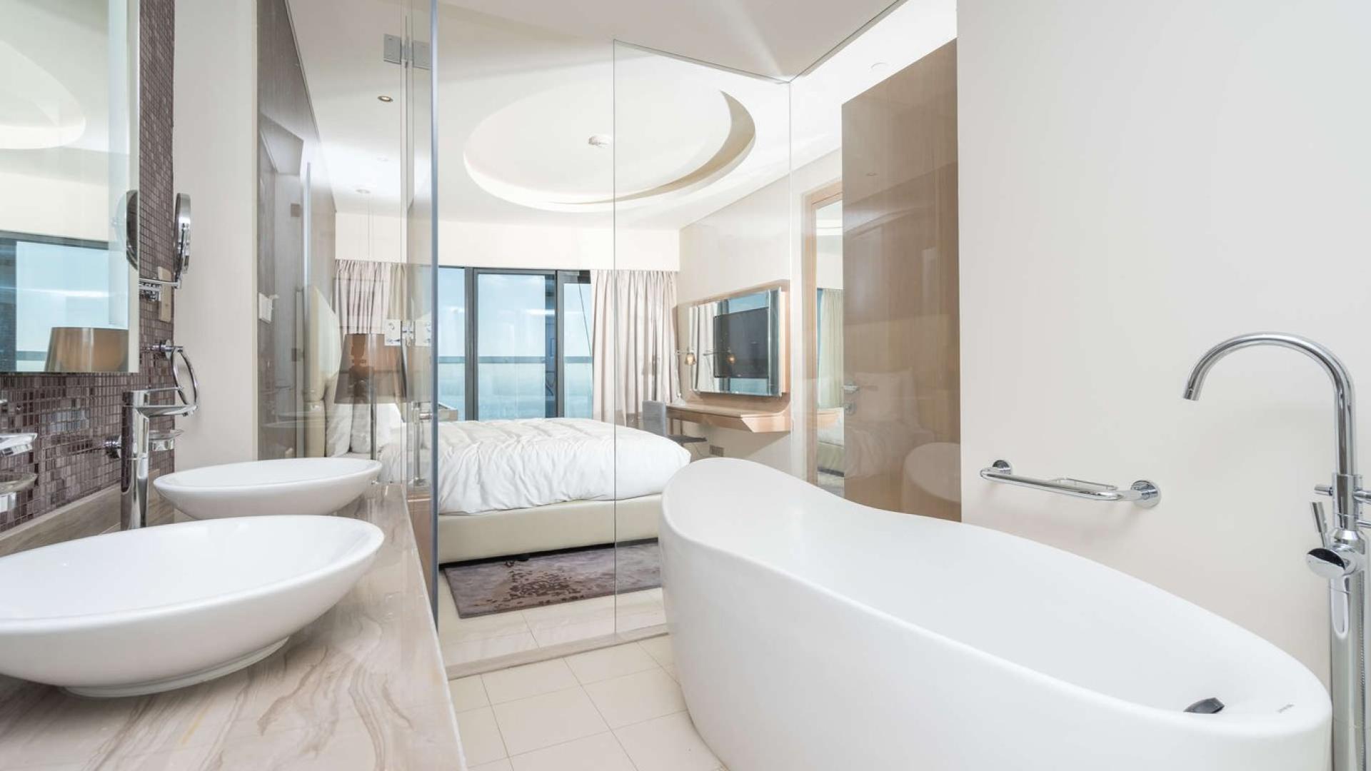 Modern living and dining area in three-bedroom apartment, Paramount Hotel, Business Bay