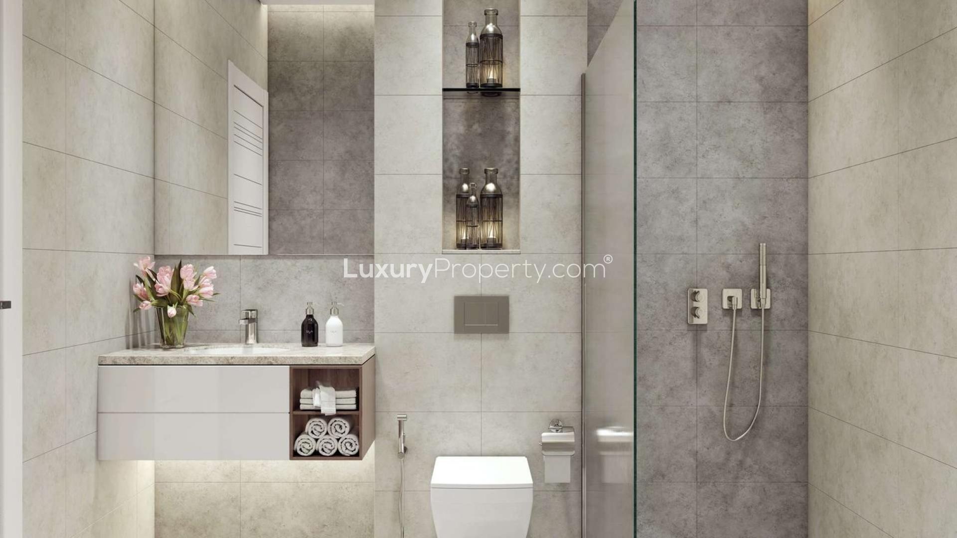 Modern exterior of Pantheon Elysee apartment building in Jumeirah Village Circle at dusk