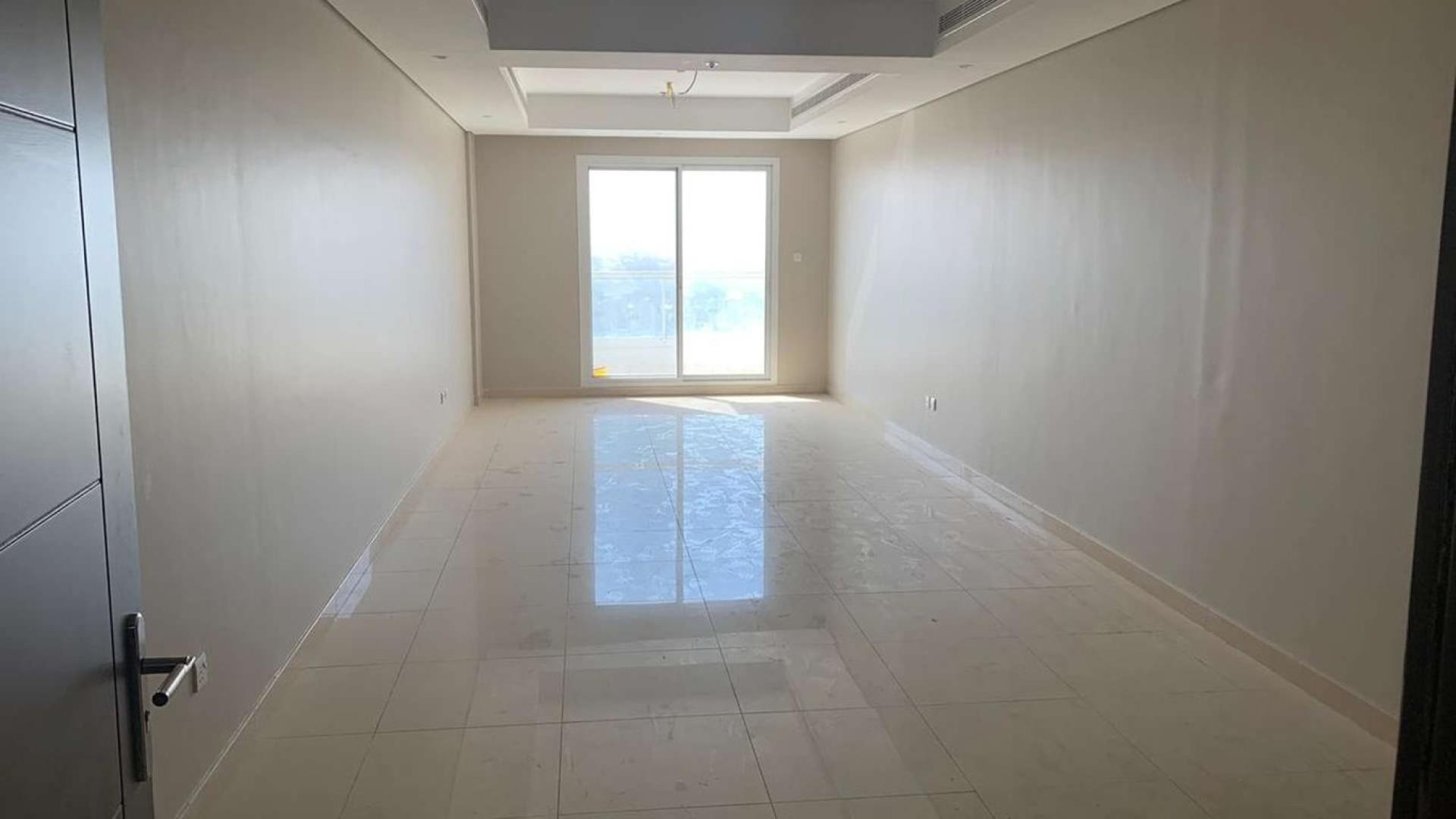 Spacious living room with large window in Dubailand apartment for sale, Hercules Tower