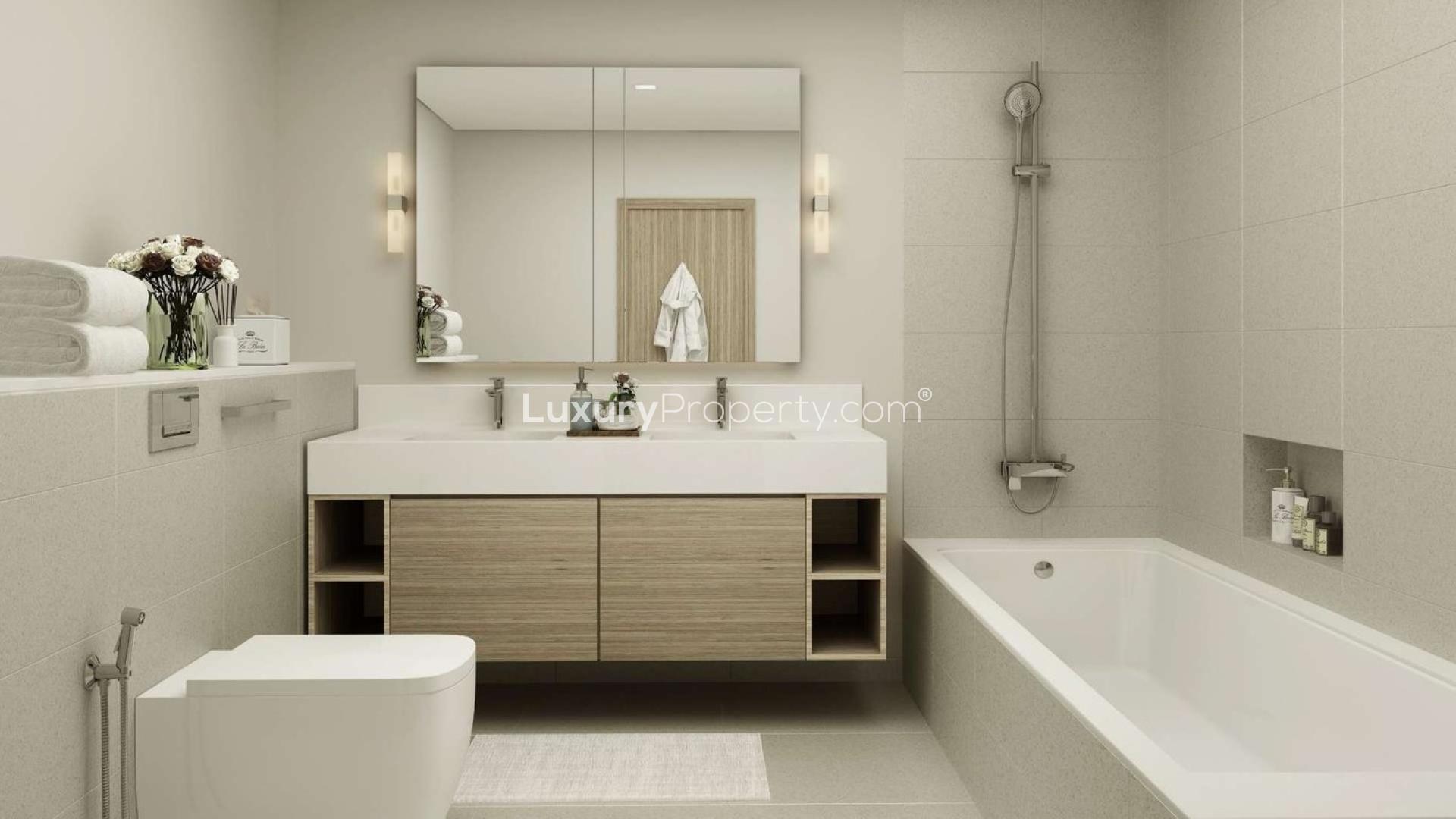 Modern bathroom in one-bedroom apartment, Dubai Creek Harbour, featuring sleek fixtures and bathtub