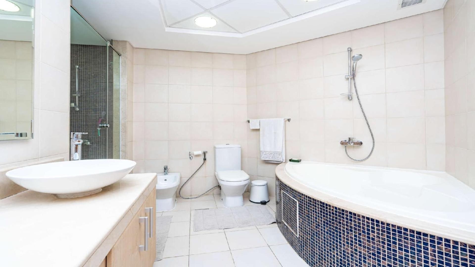 Dining area with glass table in Al Nabat Shoreline Apartments, Palm Jumeirah
