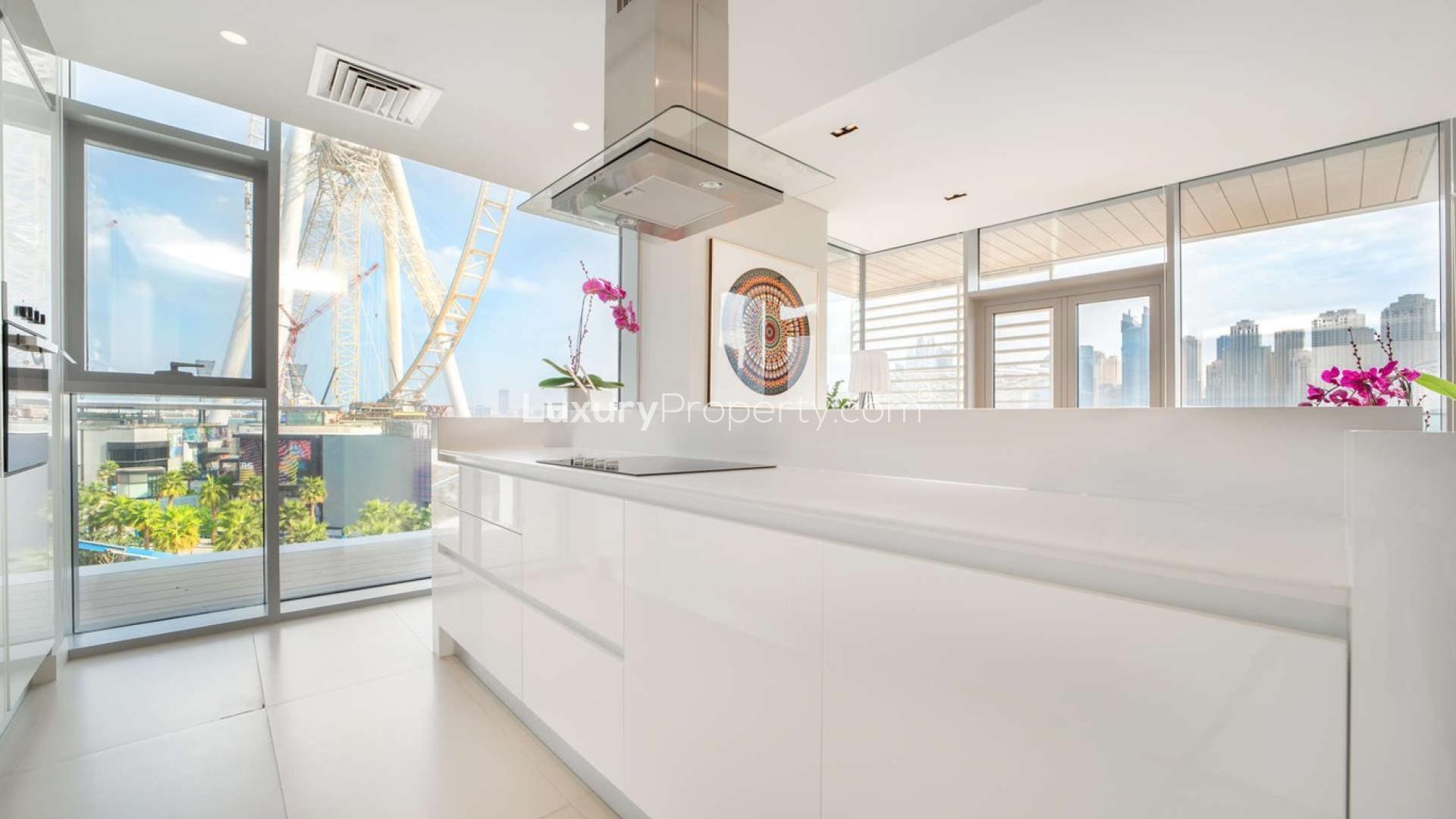 Outdoor pool area at Bluewaters Residences apartment complex, JBR, with seating and greenery