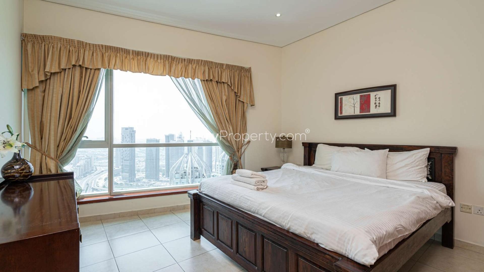 Furnished bedroom with skyline view in Marina Heights apartment, Dubai Marina