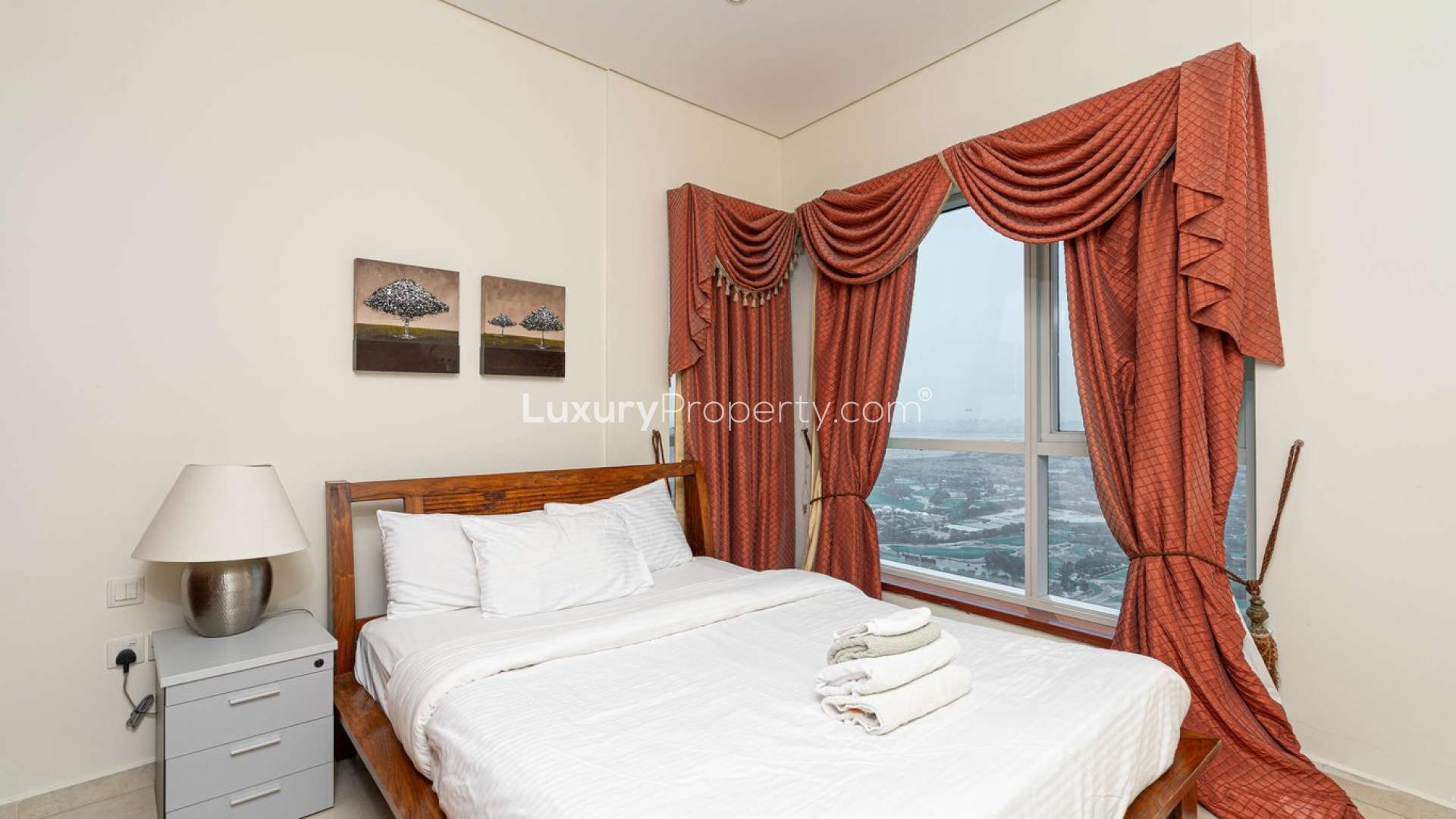 "Stunning Marina Heights apartment tower exterior in Dubai Marina, available for sale.",Furnished bedroom with window view in Marina Heights, Dubai Marina apartment for sale