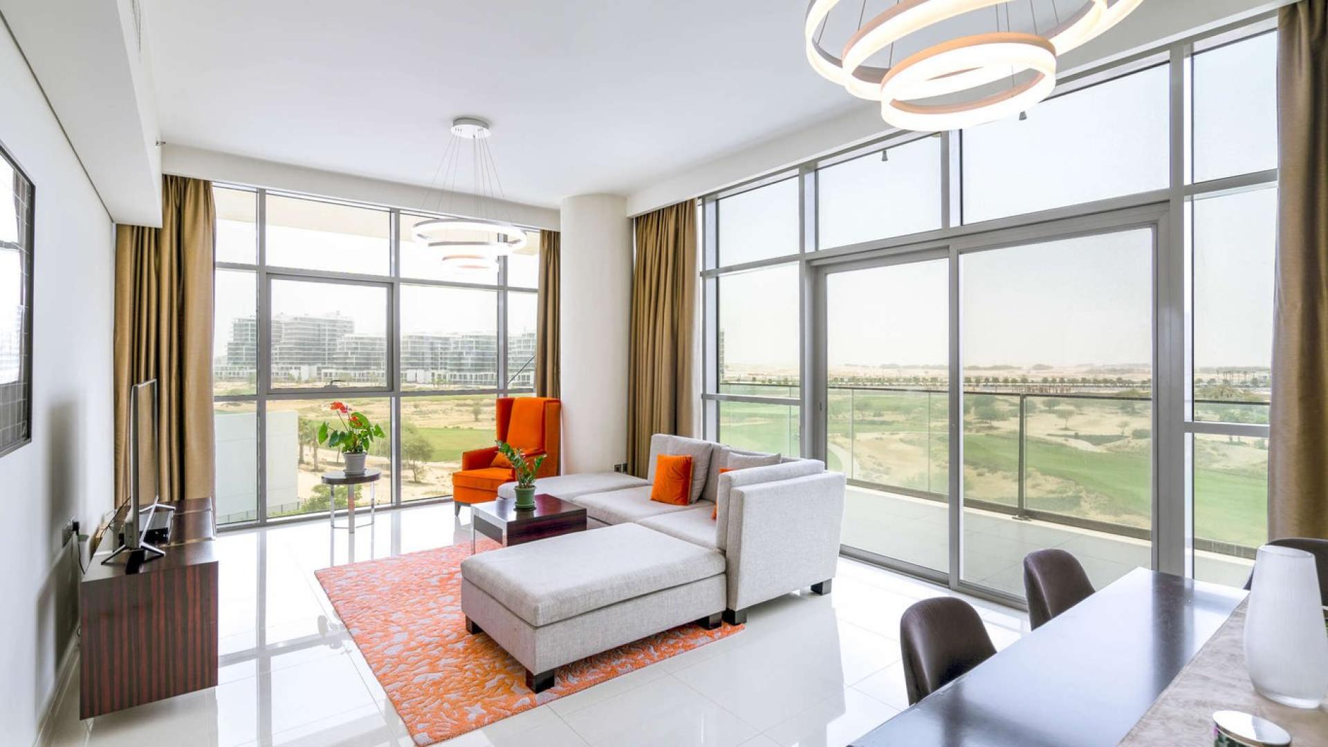 Luxurious Damac Hills apartment living room with stunning full golf course view