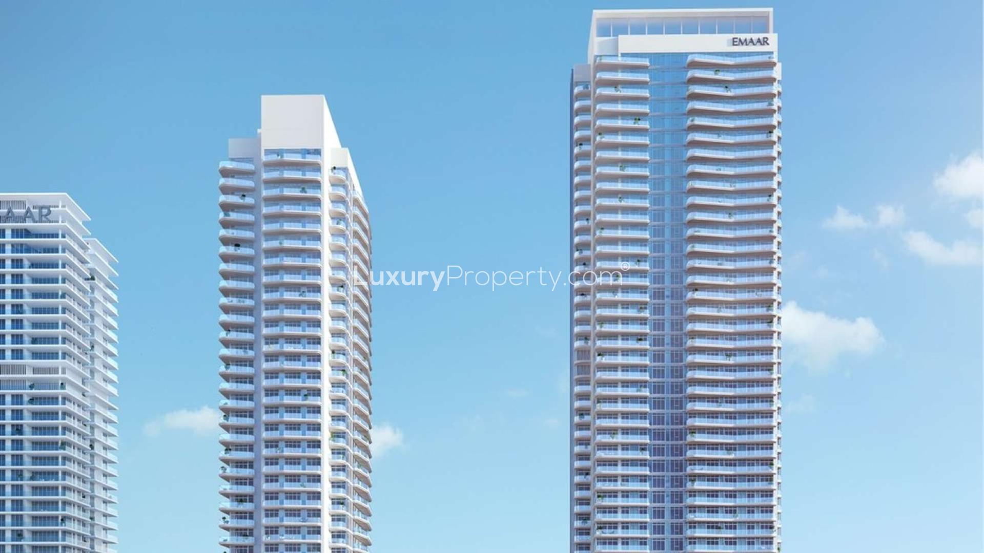 Emaar Beachfront apartment towers in Dubai Harbour, clear blue sky background