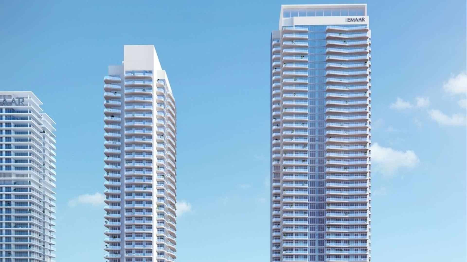 Emaar Beachfront apartment towers in Dubai Harbour, clear blue sky background