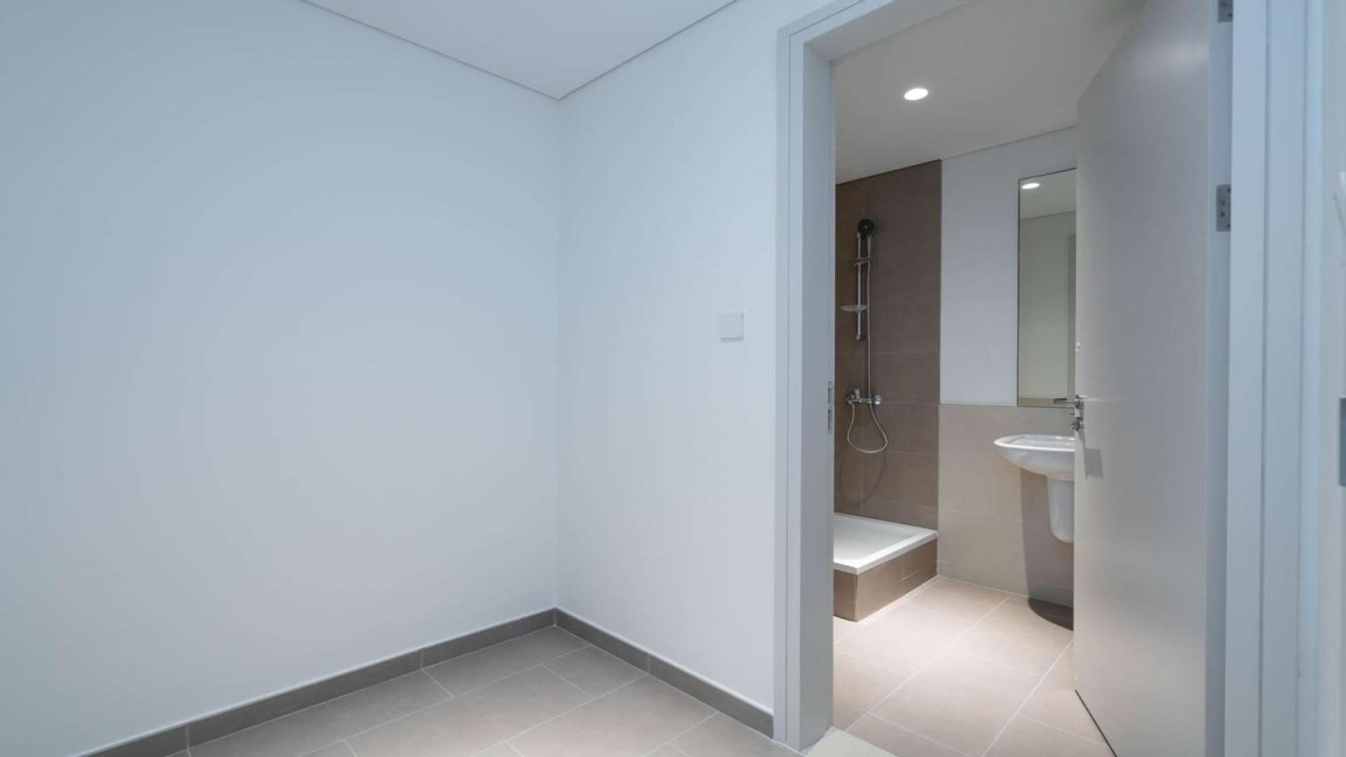 "Scenic balcony view from 3-bedroom apartment in Dubai Hills Estate, Park Heights for sale.",Modern bathroom in Dubai Hills Park Heights apartment for sale, featuring sleek design elements