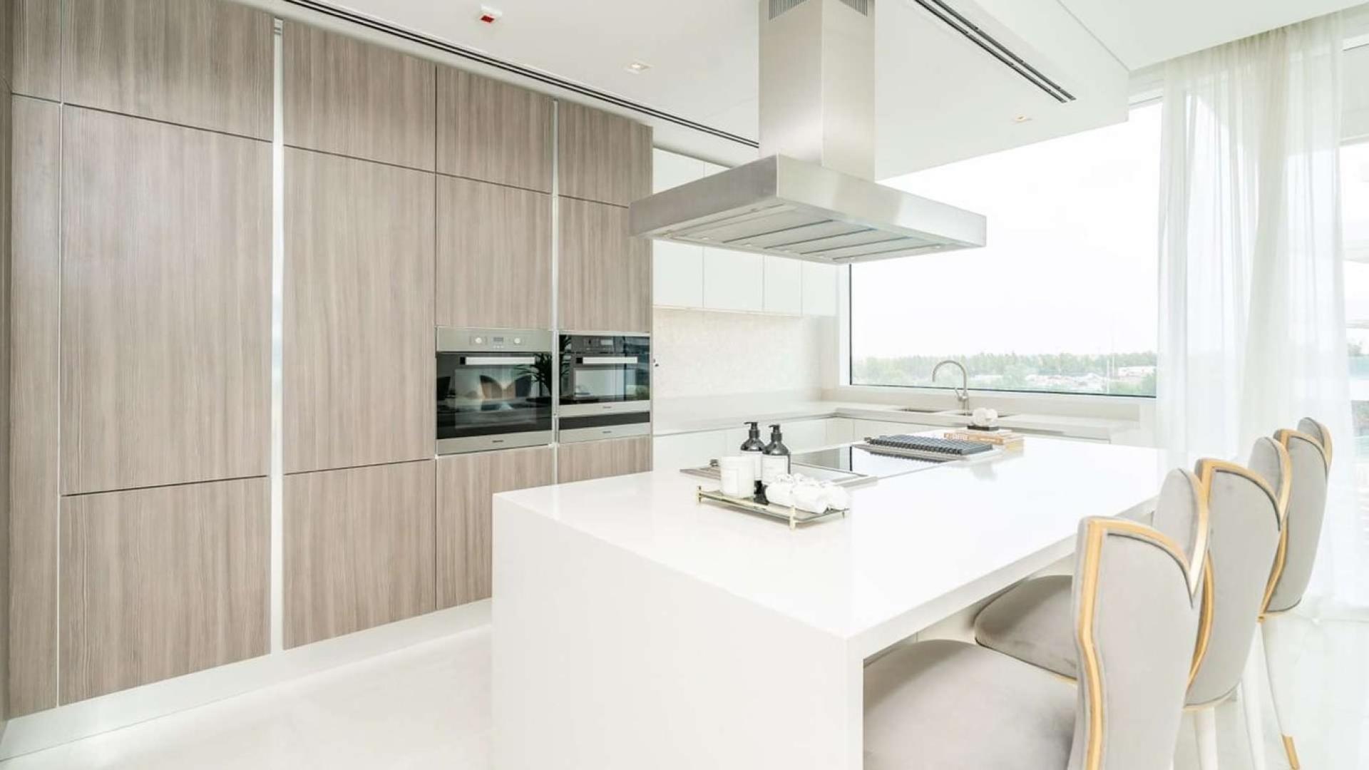 Modern living room in one-bedroom apartment, Ashjar, Al Barari, featuring elegant decor and large windows