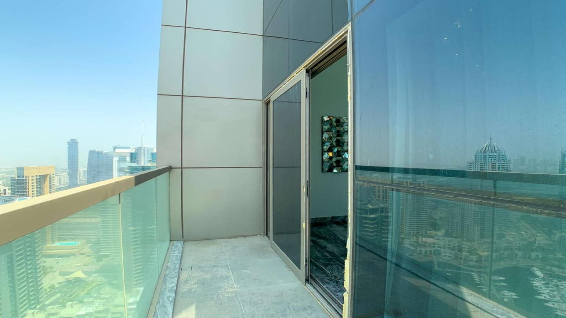 Stylish living room with marina view in three-bedroom Dubai Marina apartment for sale