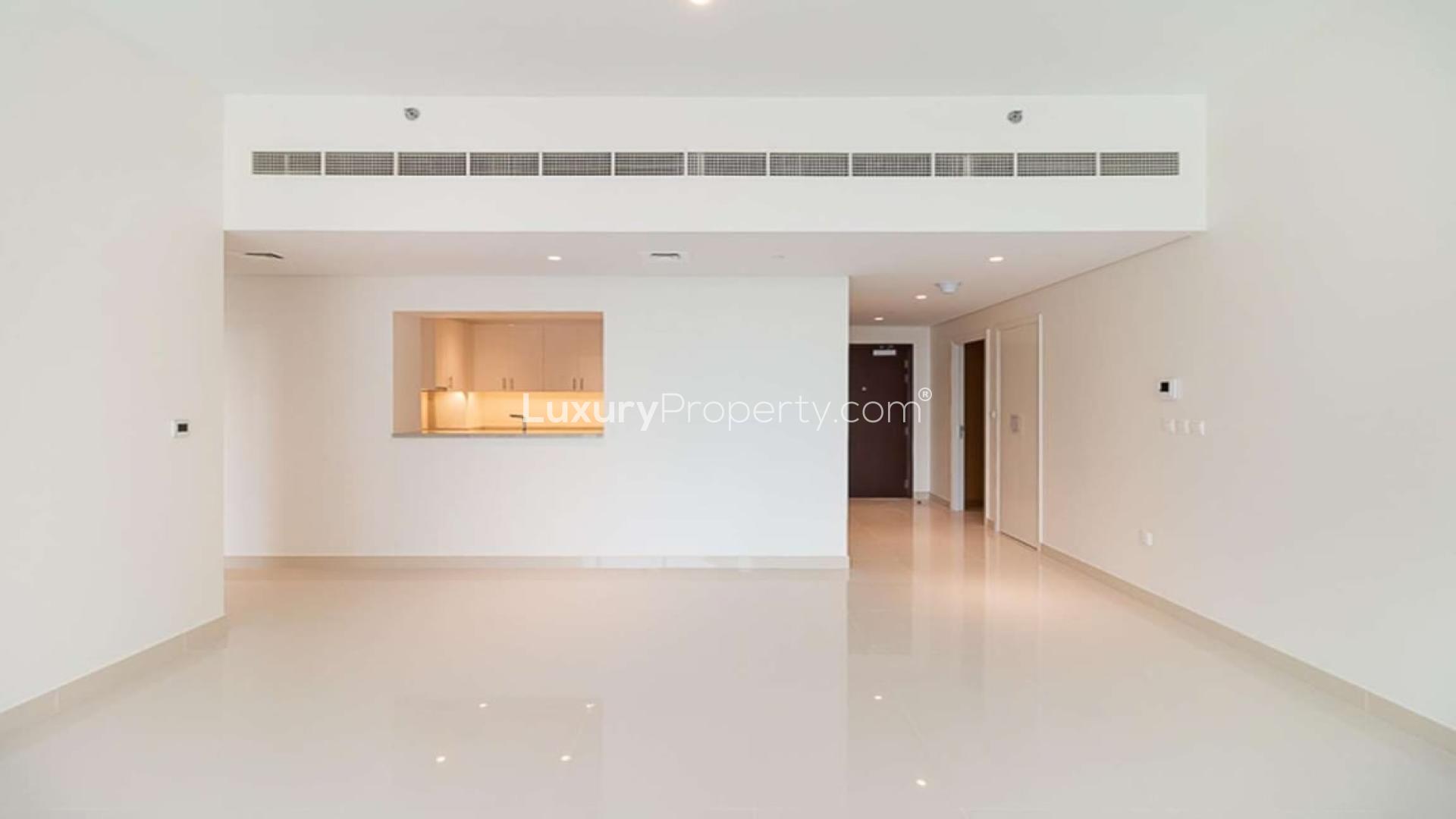 BLVD Crescent apartment view with pool, gardens, and Downtown Dubai skyline in background