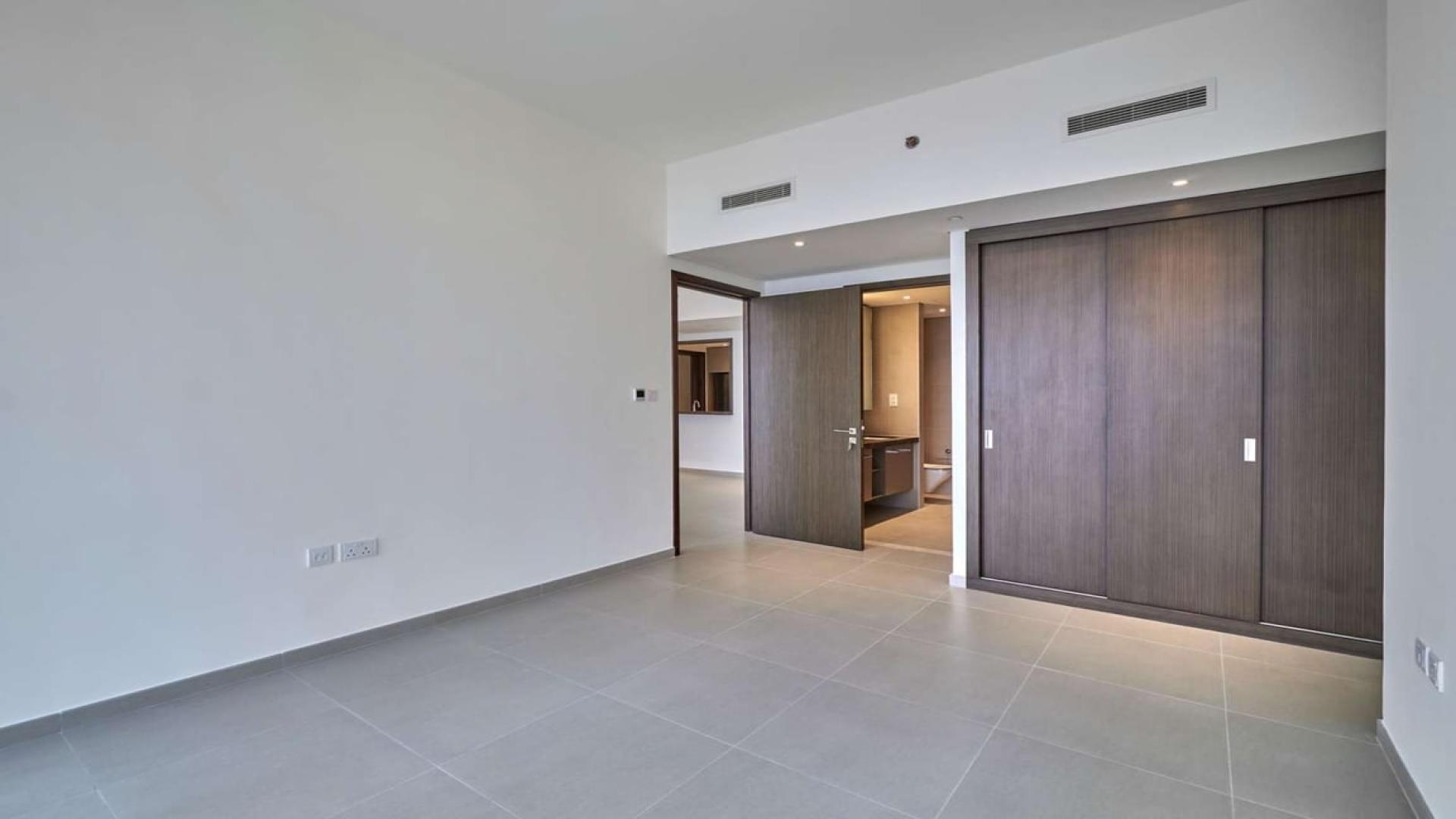 Empty room with large windows in BLVD Heights apartment, Downtown Dubai