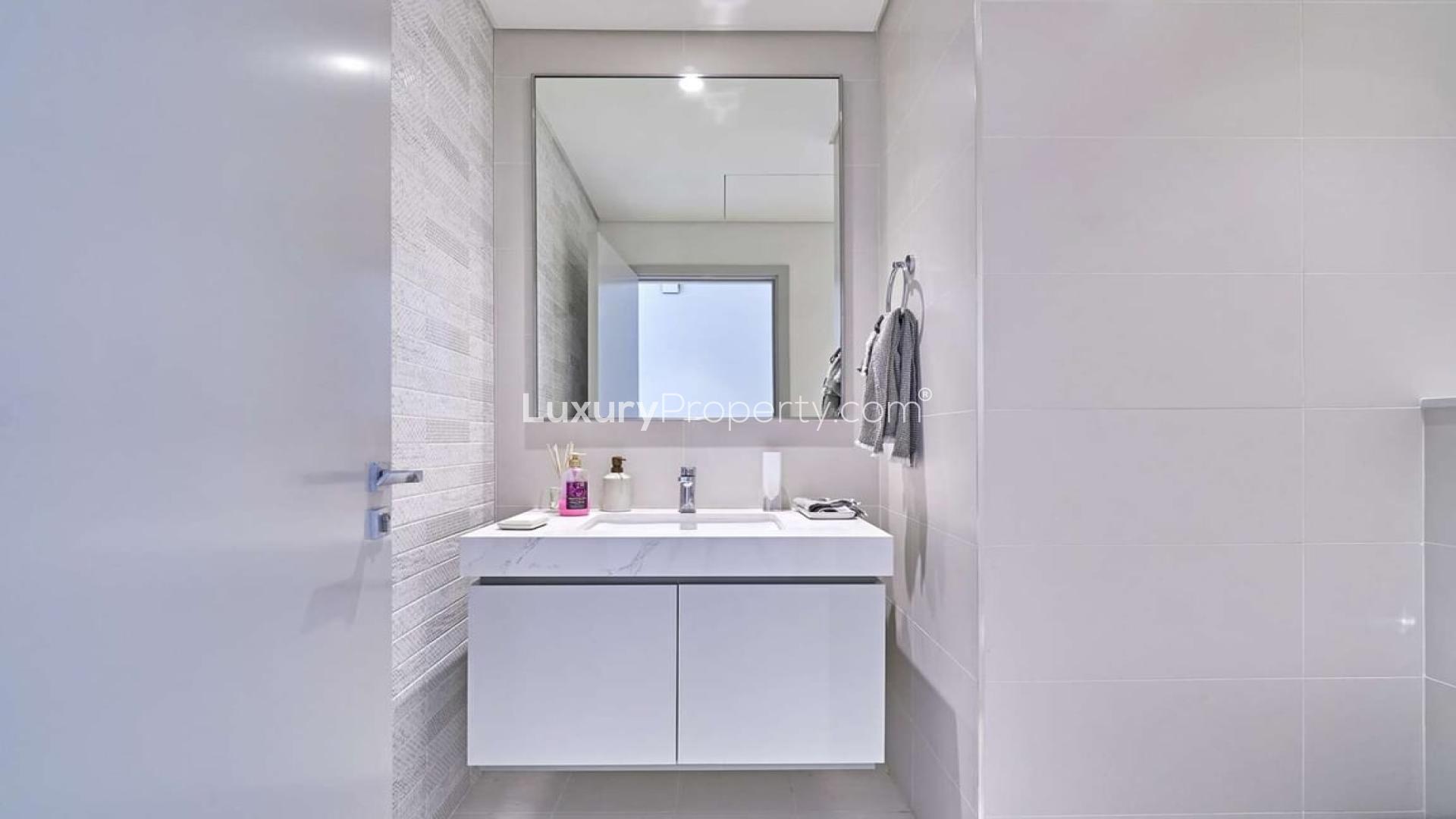 Chic Dubai Harbour apartment living room with waterfront views, modern decor, and large windows