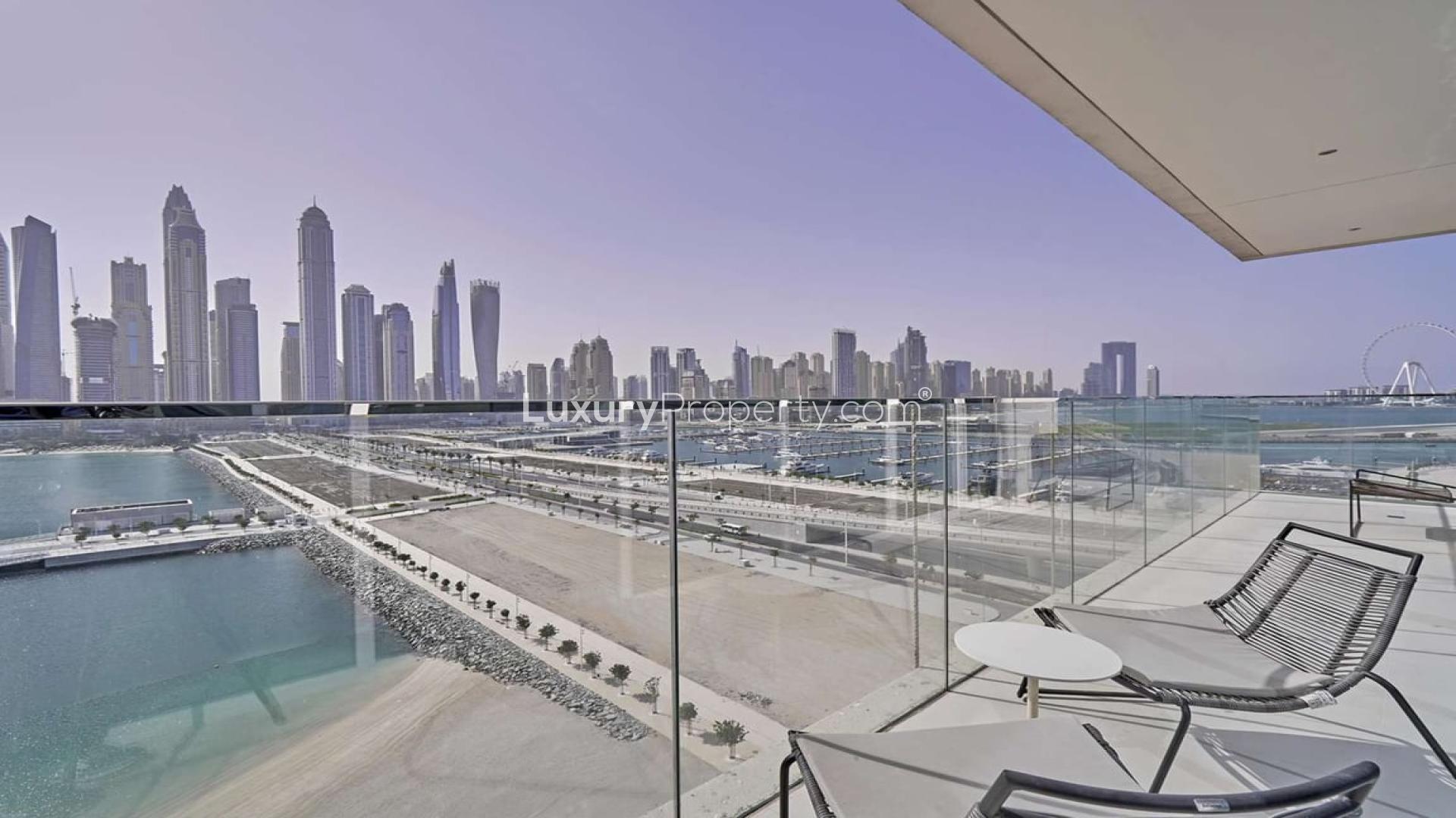 Furnished waterfront apartment balcony with stunning Dubai Harbour skyline view, Emaar Beachfront