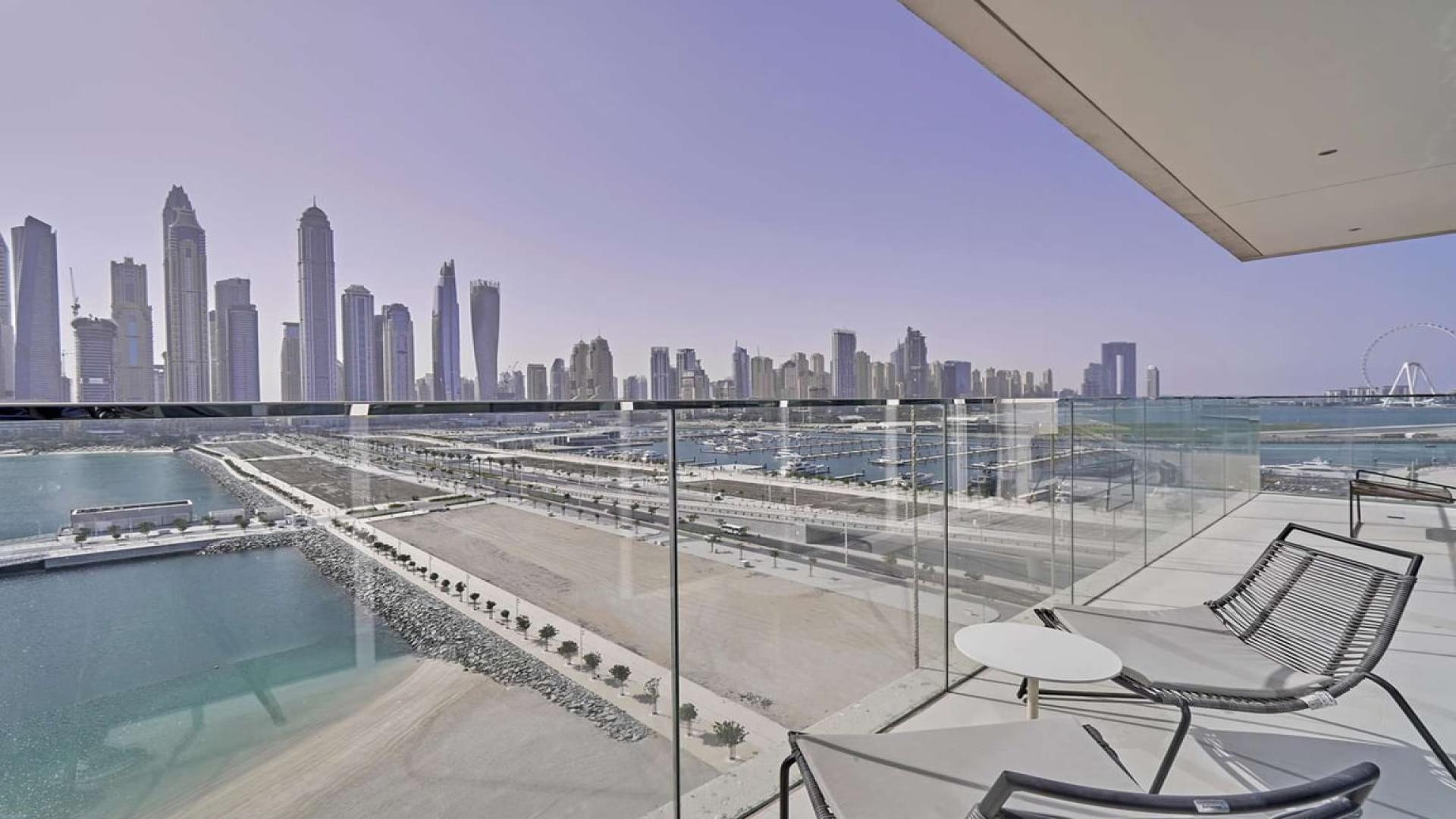 Furnished waterfront apartment balcony with stunning Dubai Harbour skyline view, Emaar Beachfront