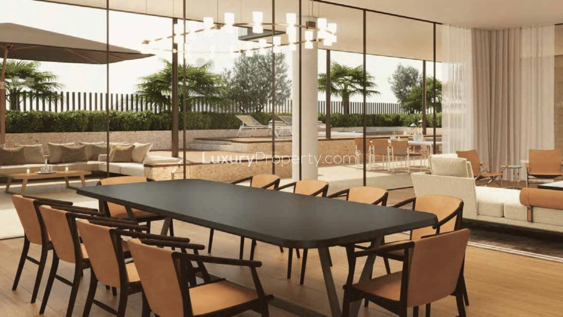 Luxurious apartment exterior on Jumeirah Bay Island, surrounded by palm trees and people