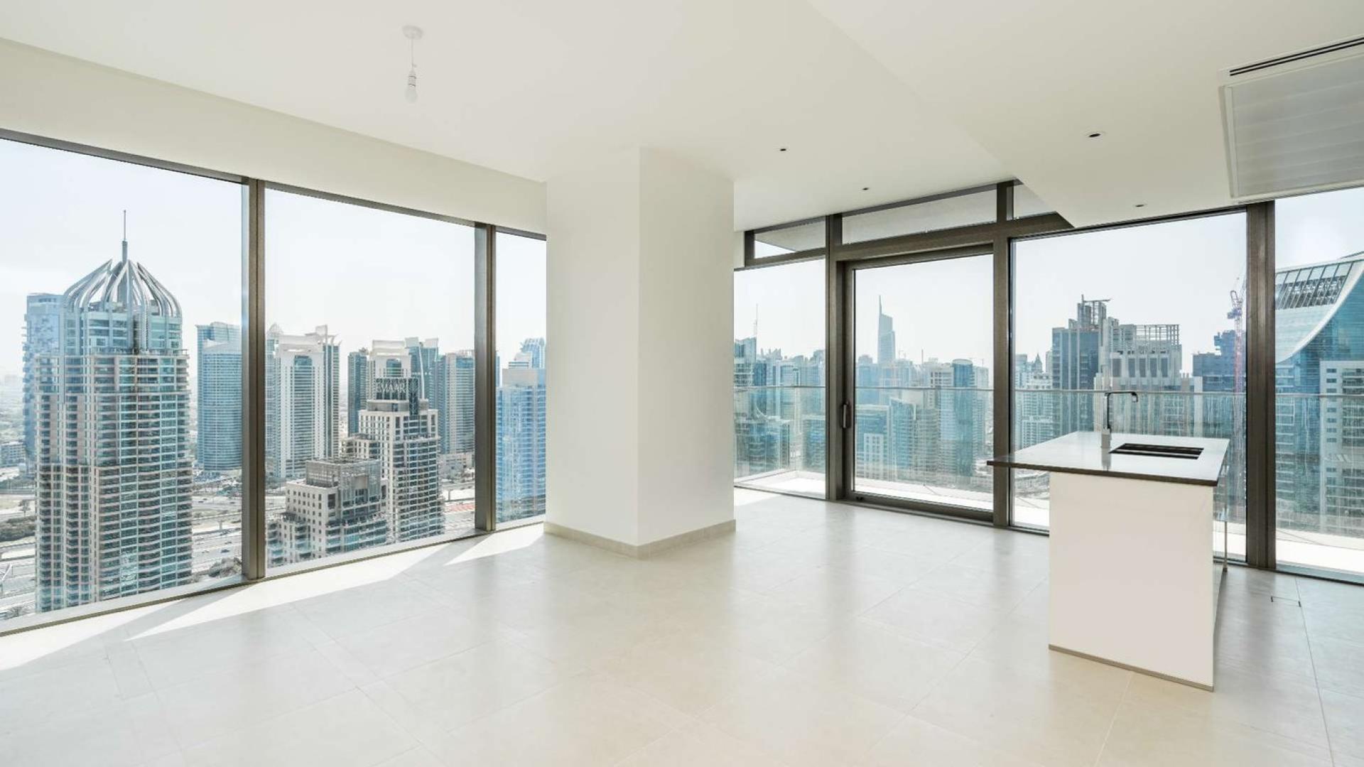 Aerial view of Dubai Marina with skyscrapers and yachts, near Marina Gate apartments for sale