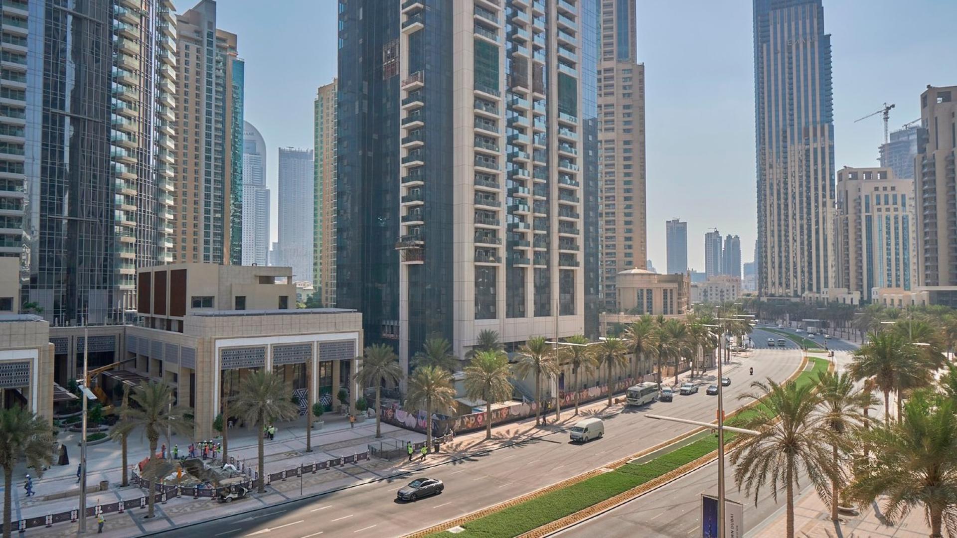 Spacious living area with floor-to-ceiling windows in Downtown Dubai duplex apartment for sale