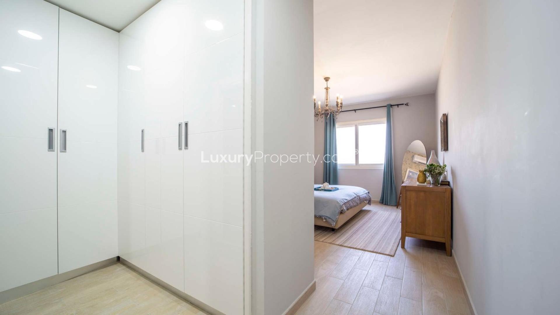 Modern open-plan living and dining area in Al Andalus apartment, Jumeirah Golf Estates