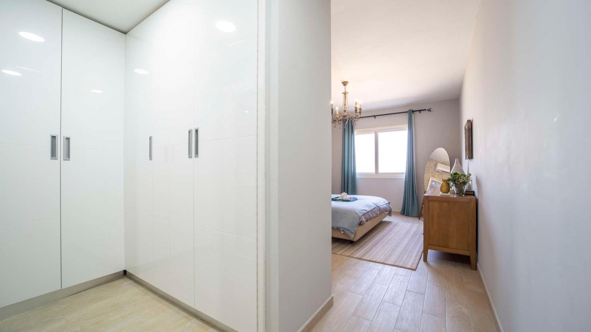 Modern open-plan living and dining area in Al Andalus apartment, Jumeirah Golf Estates