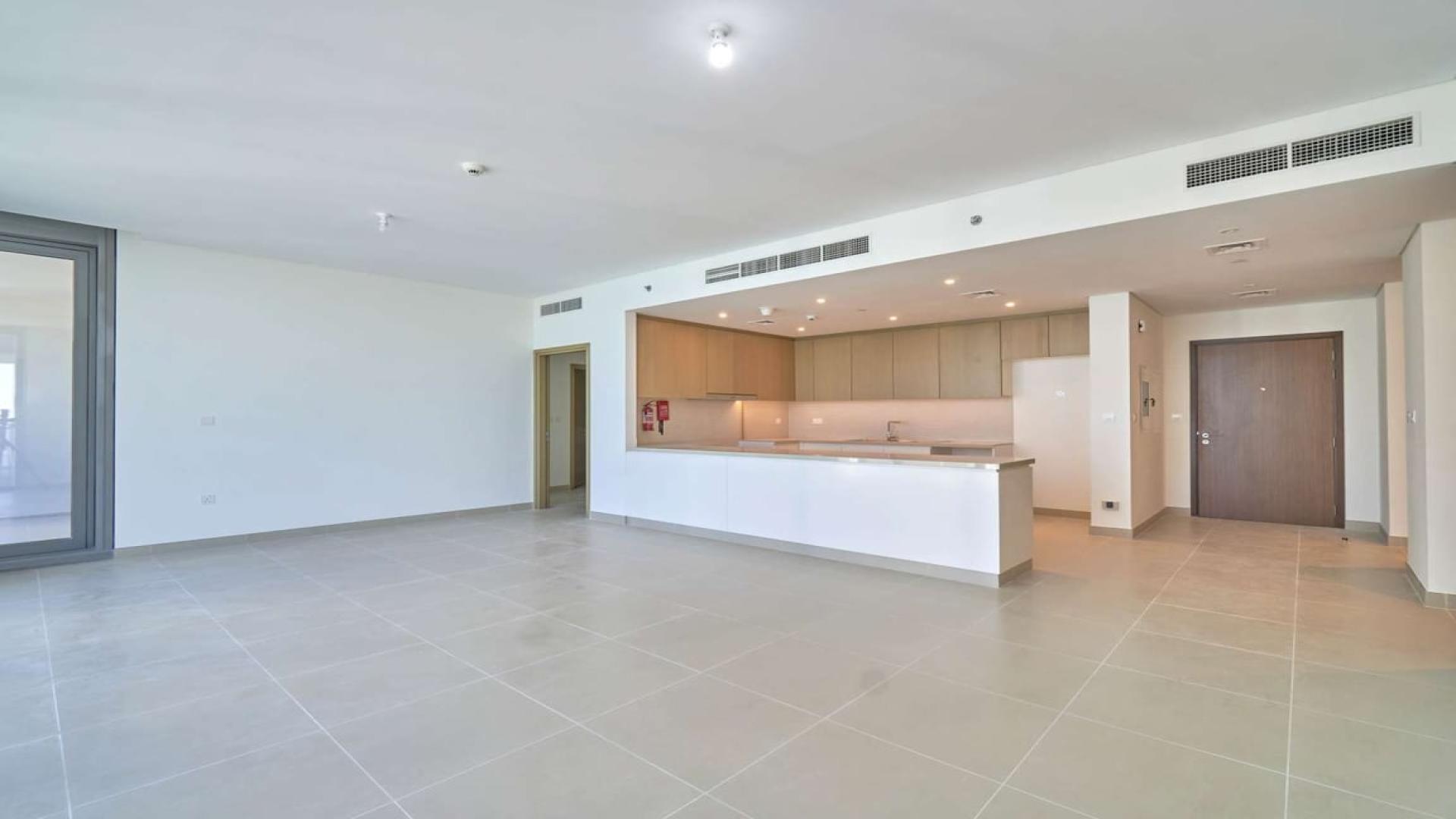 Spacious Dubai Marina apartment living area with modern open kitchen, high floor, vacant