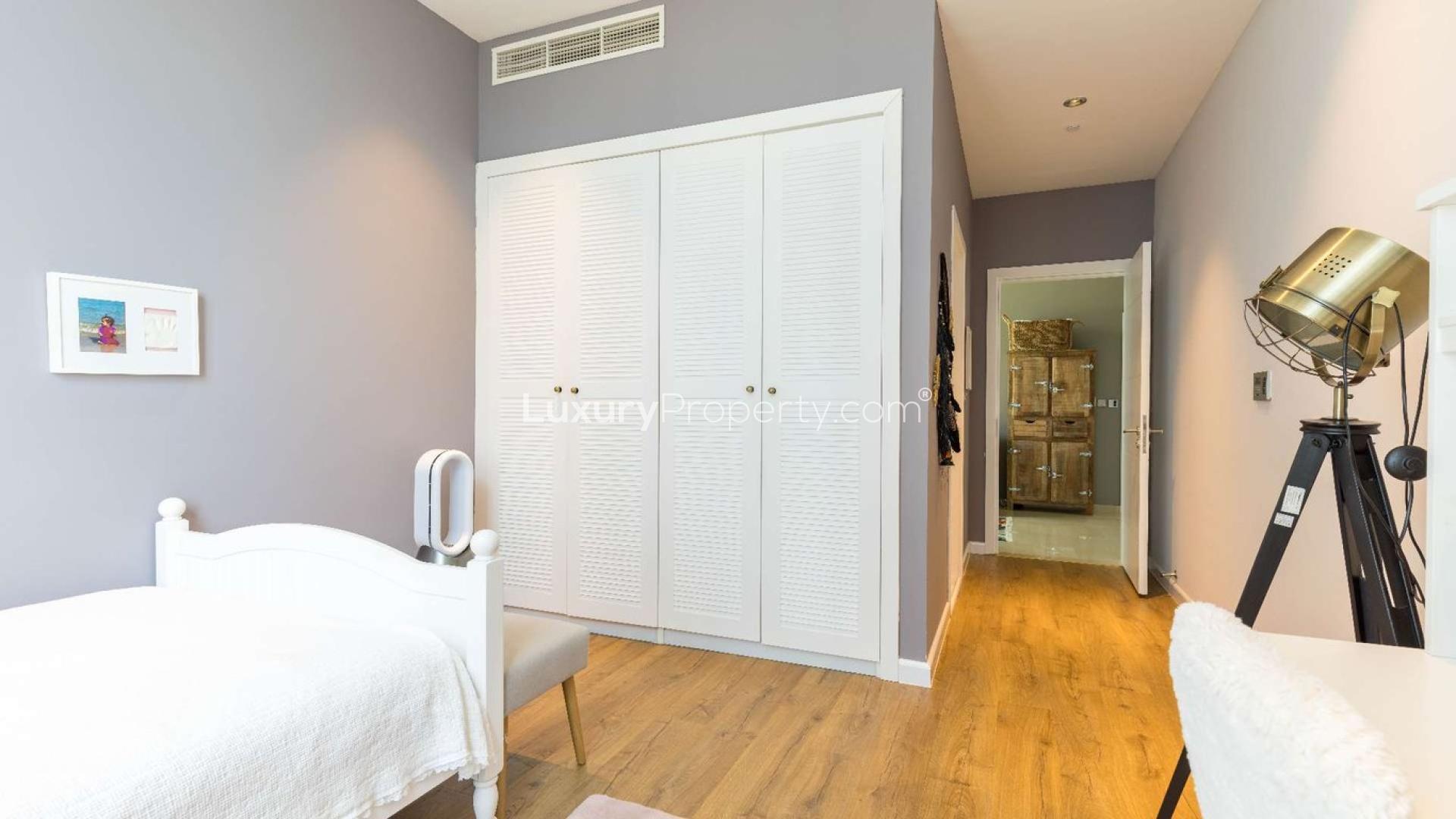 Luxurious living room in upgraded Palm Jumeirah apartment, featuring modern decor and large windows