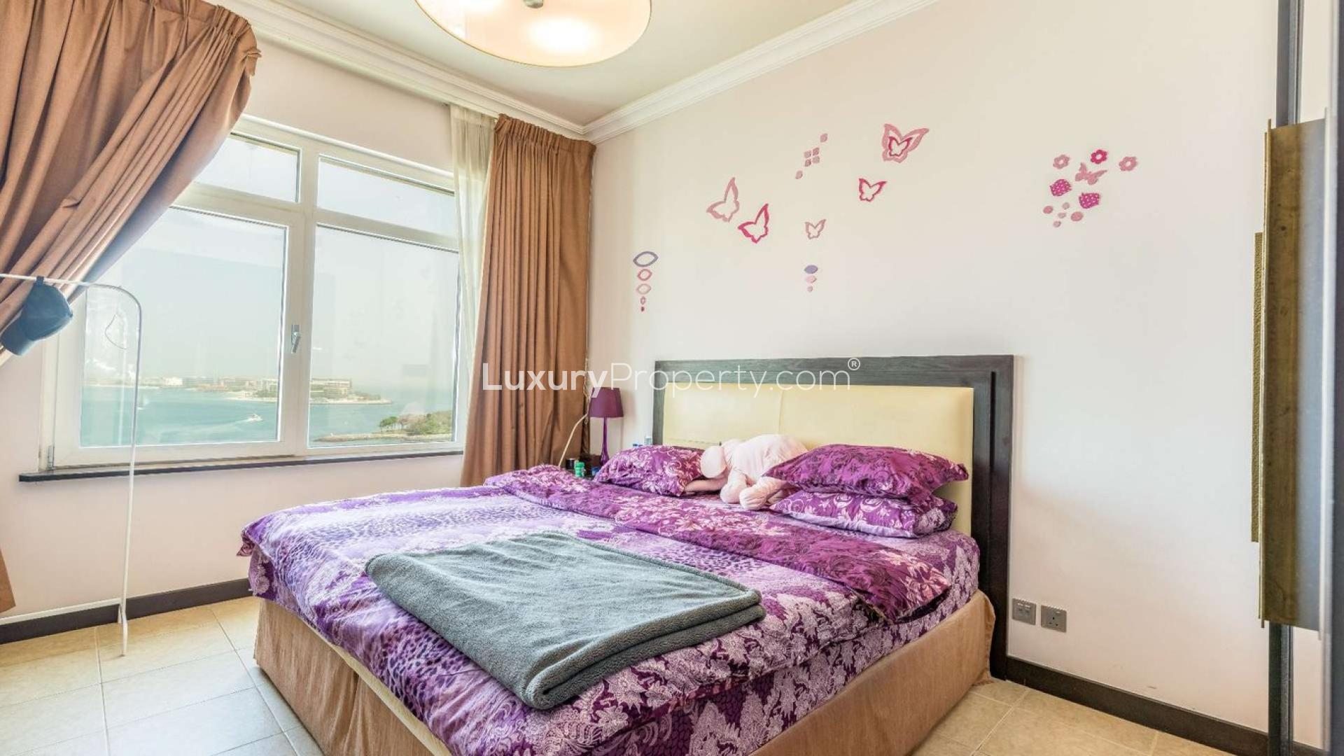 Sea view bedroom in Palm Jumeirah apartment, featuring elegant decor and large window
