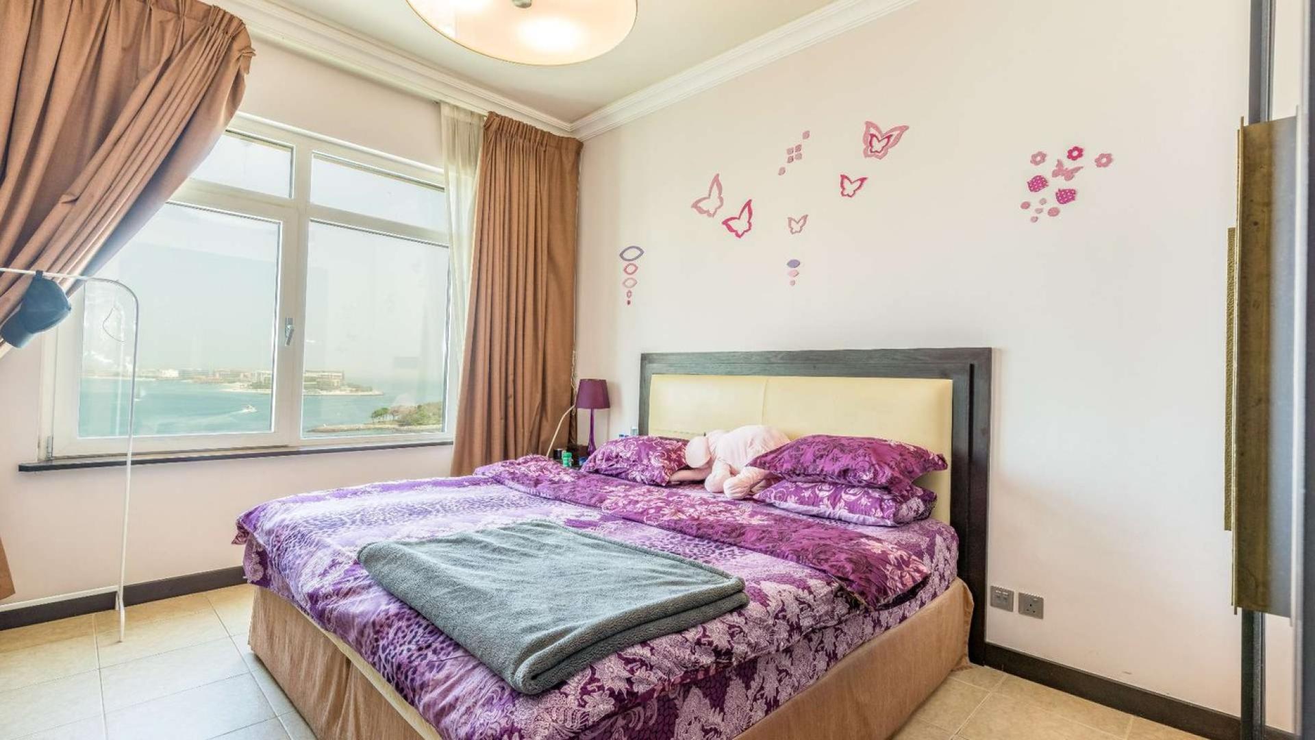 Sea view bedroom in Palm Jumeirah apartment, featuring elegant decor and large window