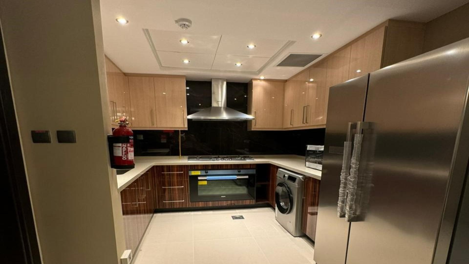 N/A,Modern kitchen in fully furnished 3-bedroom apartment, Elite Downtown Residence, Downtown Dubai