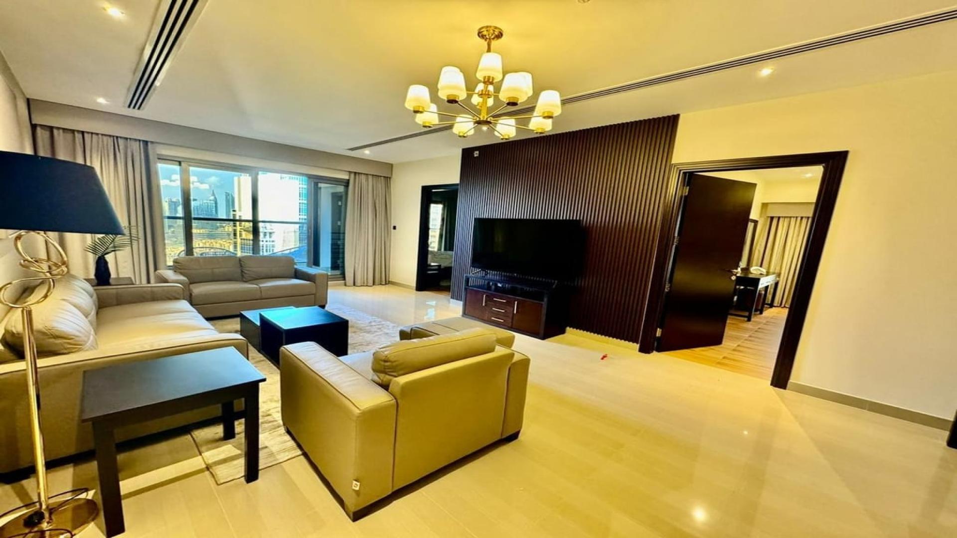 Modern furnished living room with Burj Khalifa view in Downtown Dubai apartment for sale