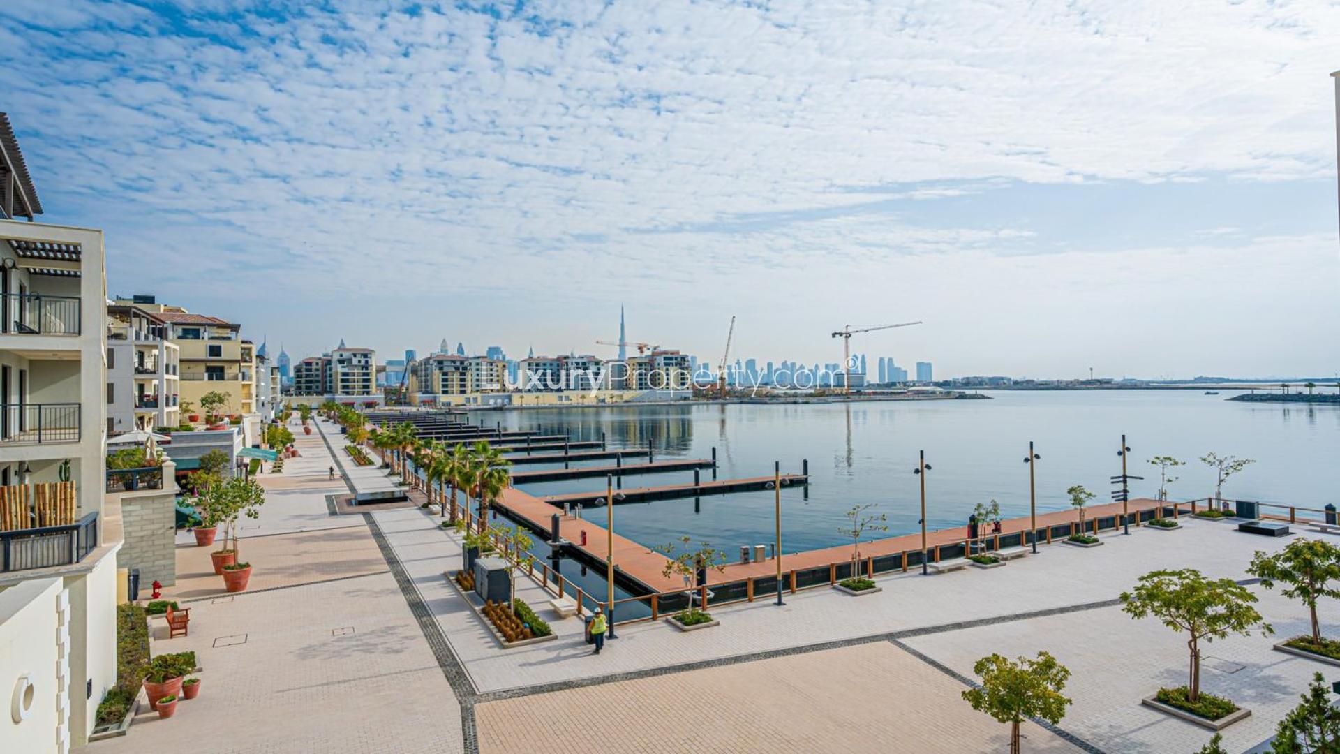 Waterfront apartment balcony view, La Mer, Jumeirah, showcasing skyline and marina scenery