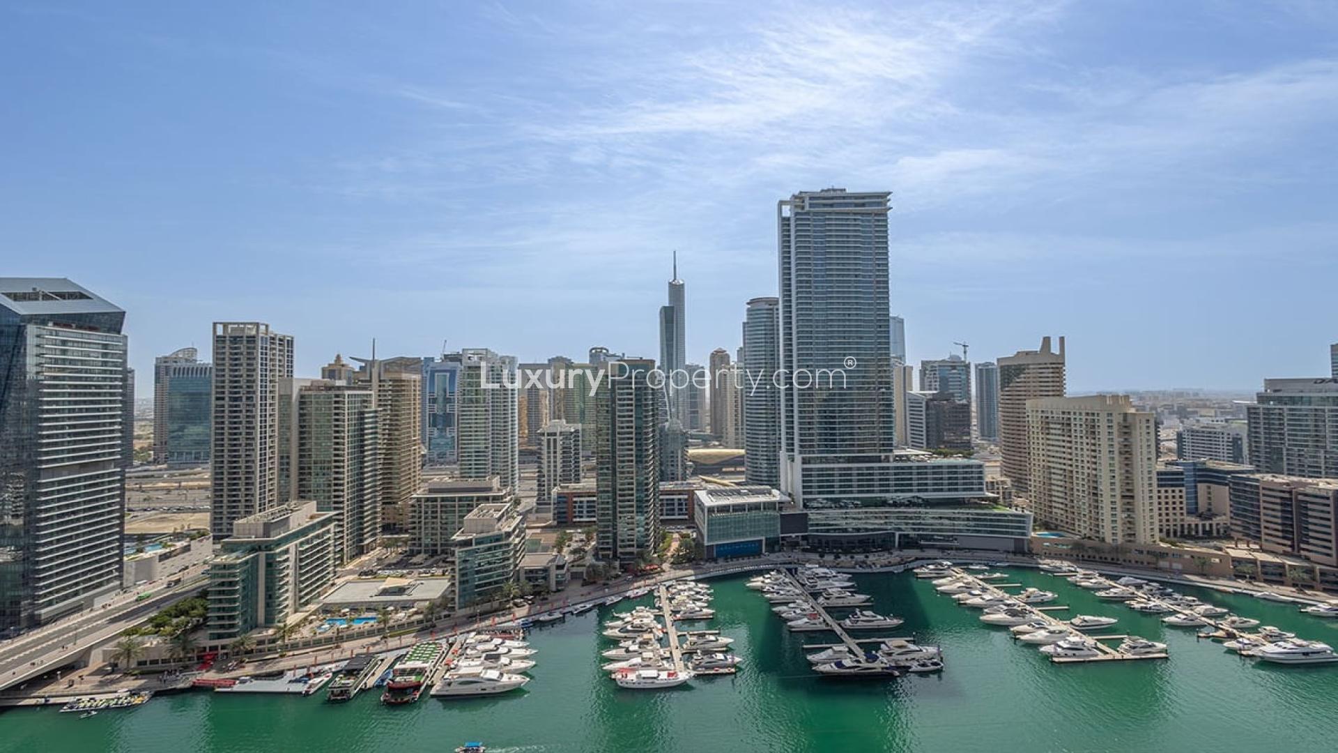 Bright living room in upgraded Dubai Marina apartment with stunning city views through large windows