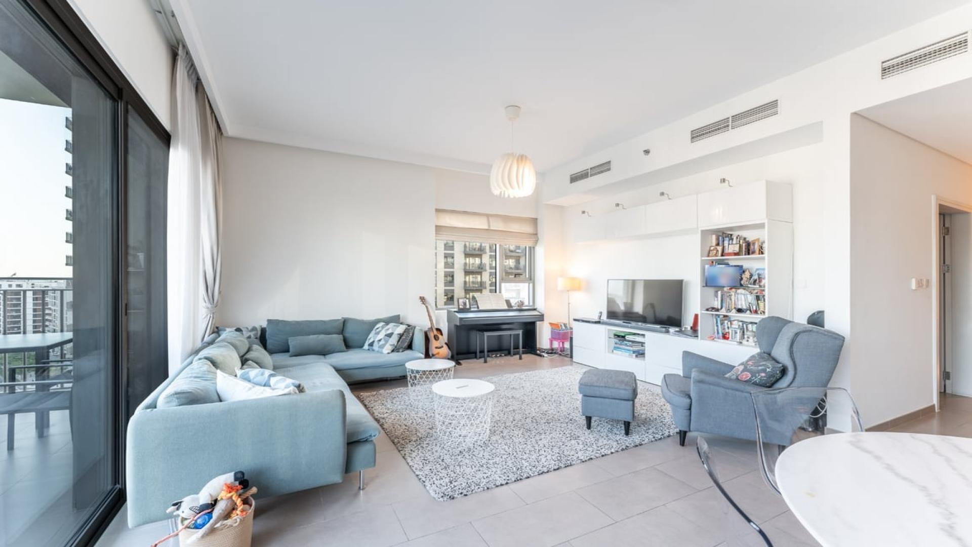 Modern living room in Dubai Hills Estate apartment, featuring elegant decor and natural light