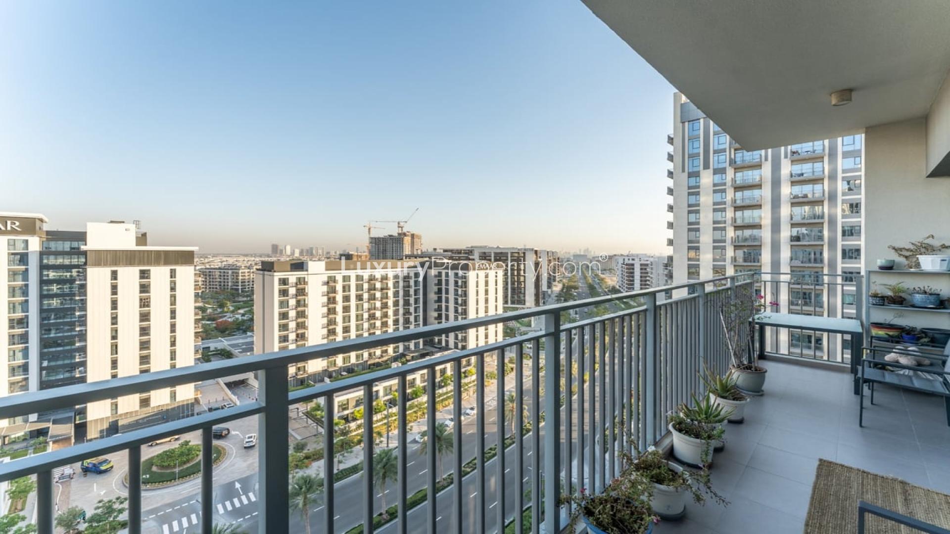 Modern living room with balcony views in Dubai Hills Estate apartment for sale