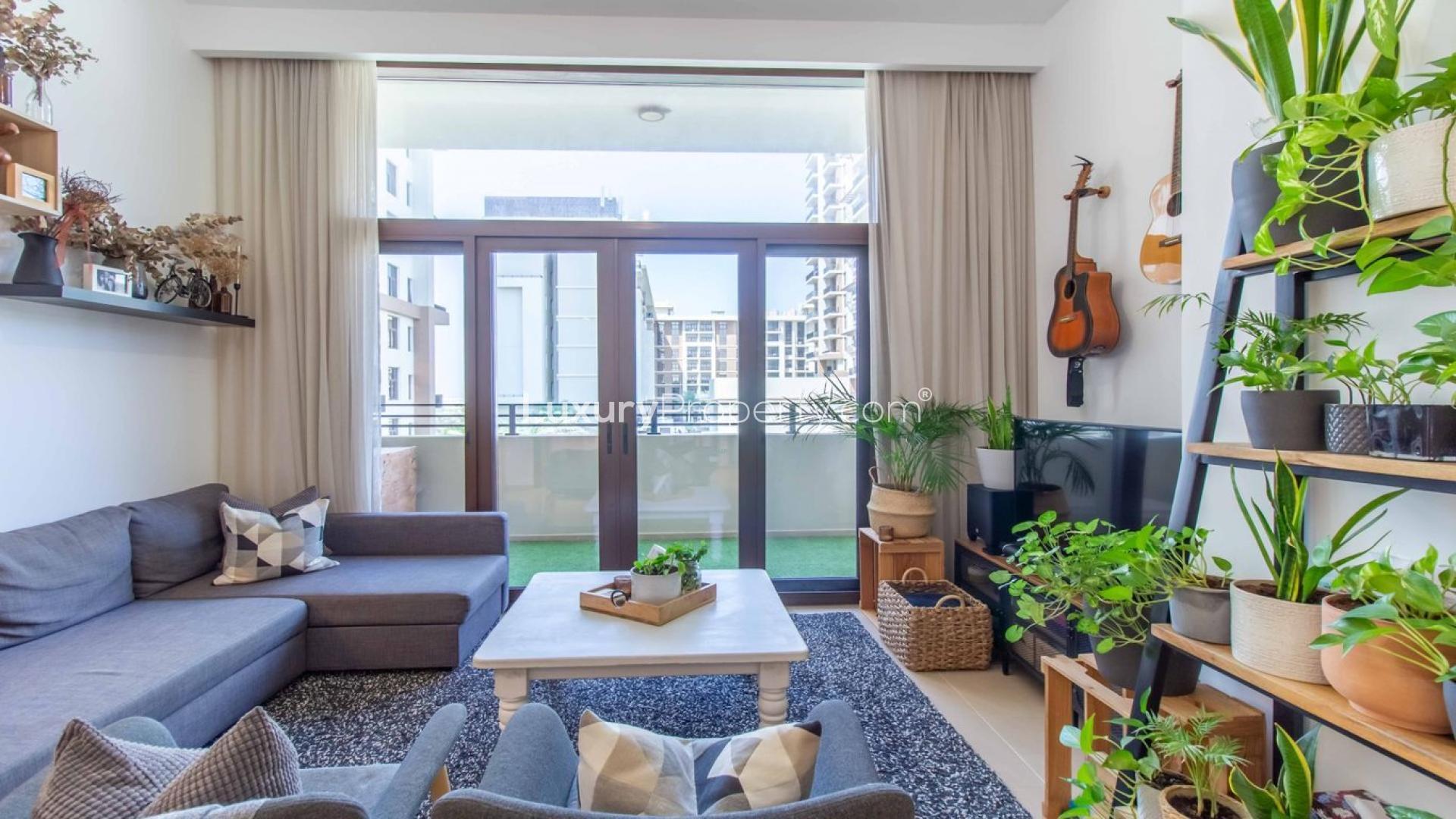 Luxurious living room in 3-bedroom Warda apartment, Town Square Dubai, with modern decor