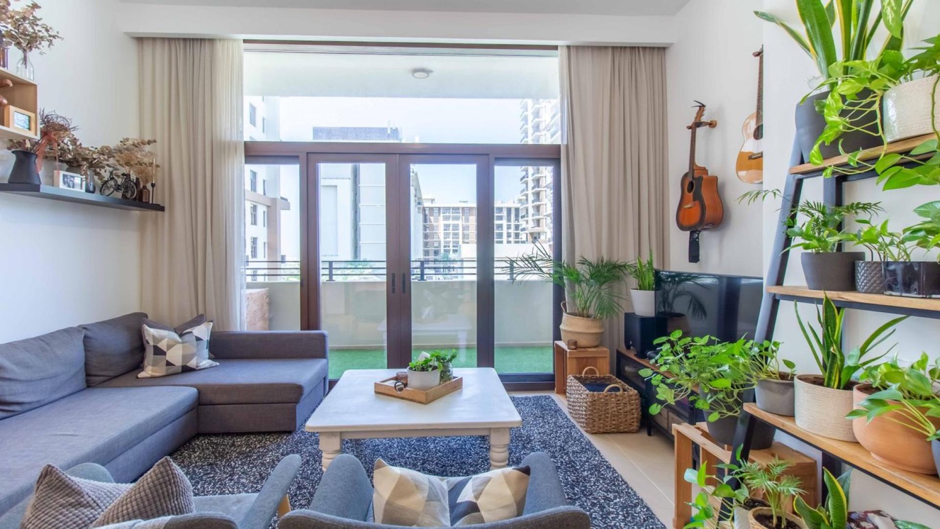 Luxurious living room in 3-bedroom Warda apartment, Town Square Dubai, with modern decor