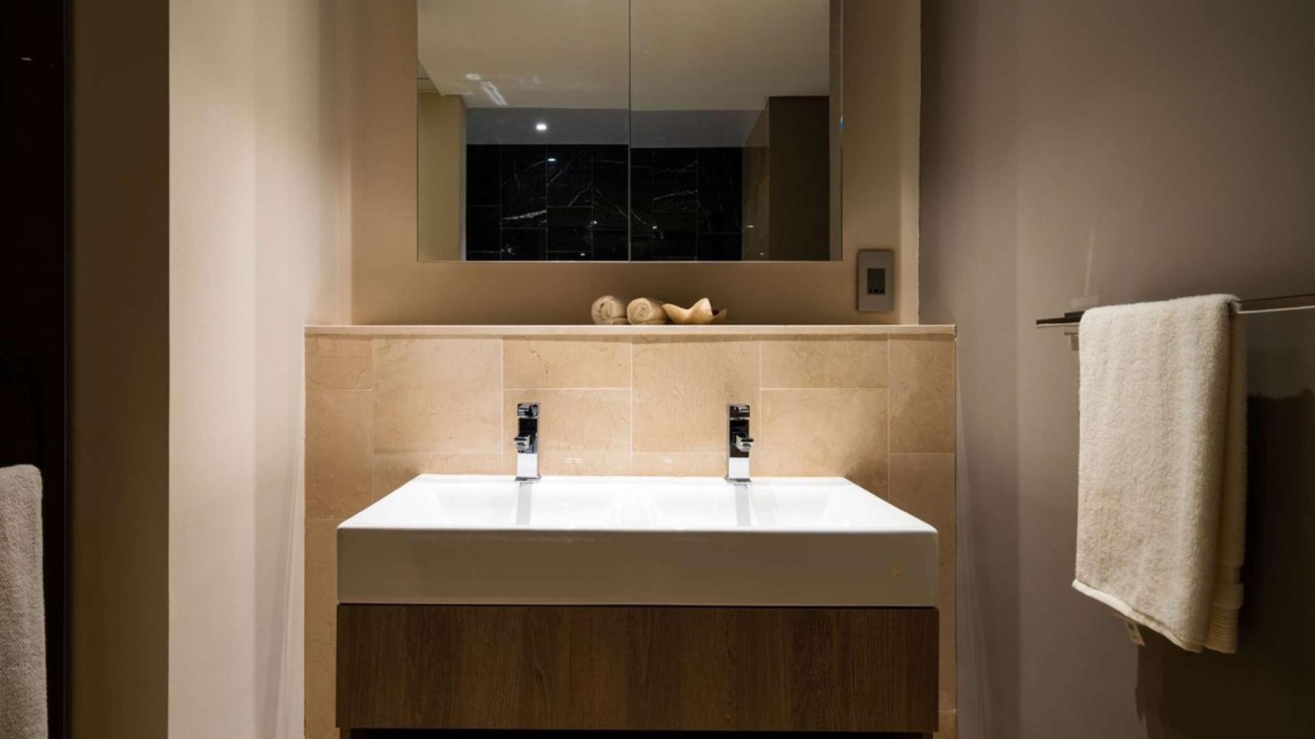 Beachfront penthouse exterior view, The 8, Palm Jumeirah, lush landscaping, modern architecture